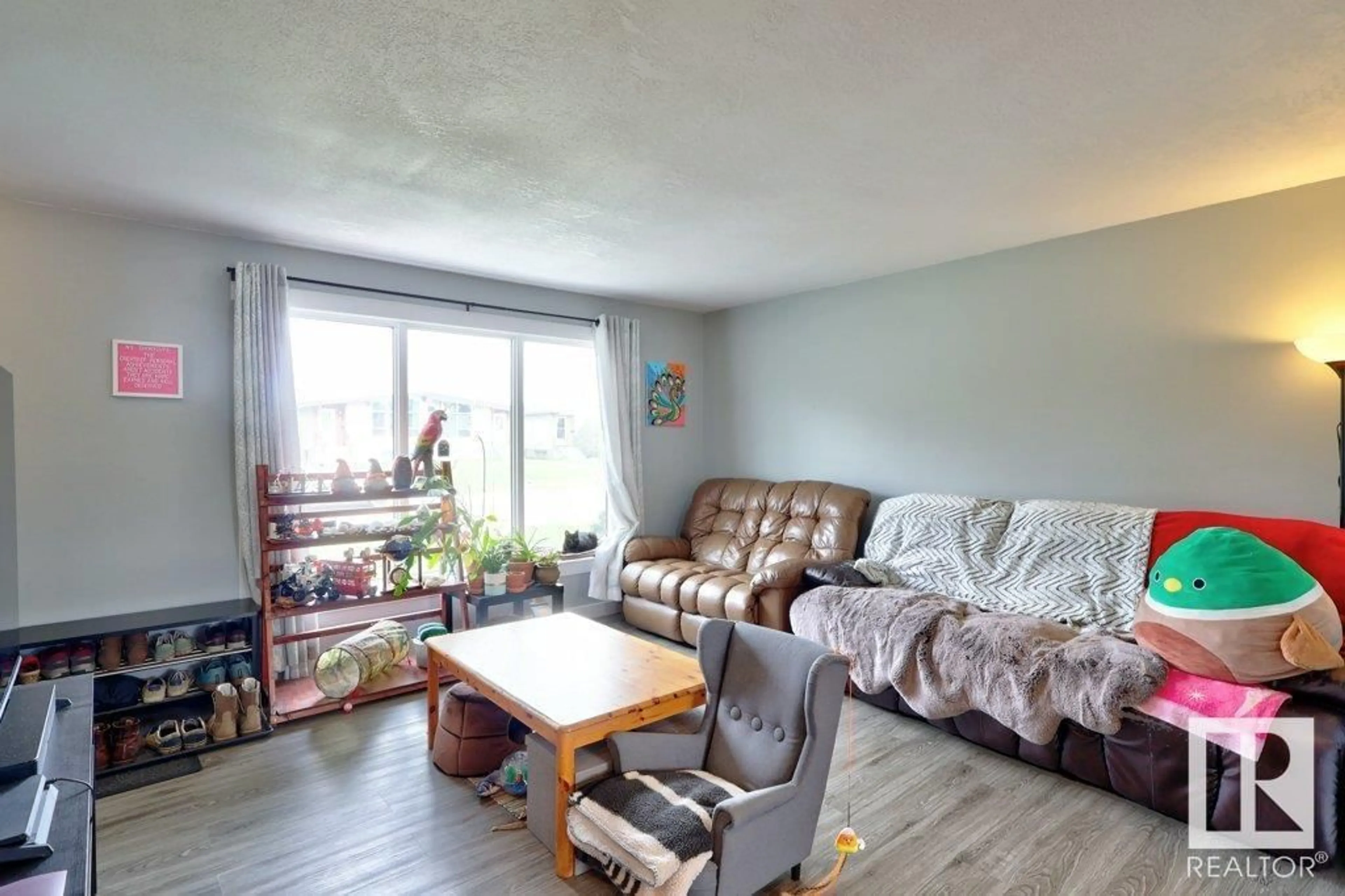 Living room with furniture, wood/laminate floor for 6034 105 ST, Edmonton Alberta T6H2N4