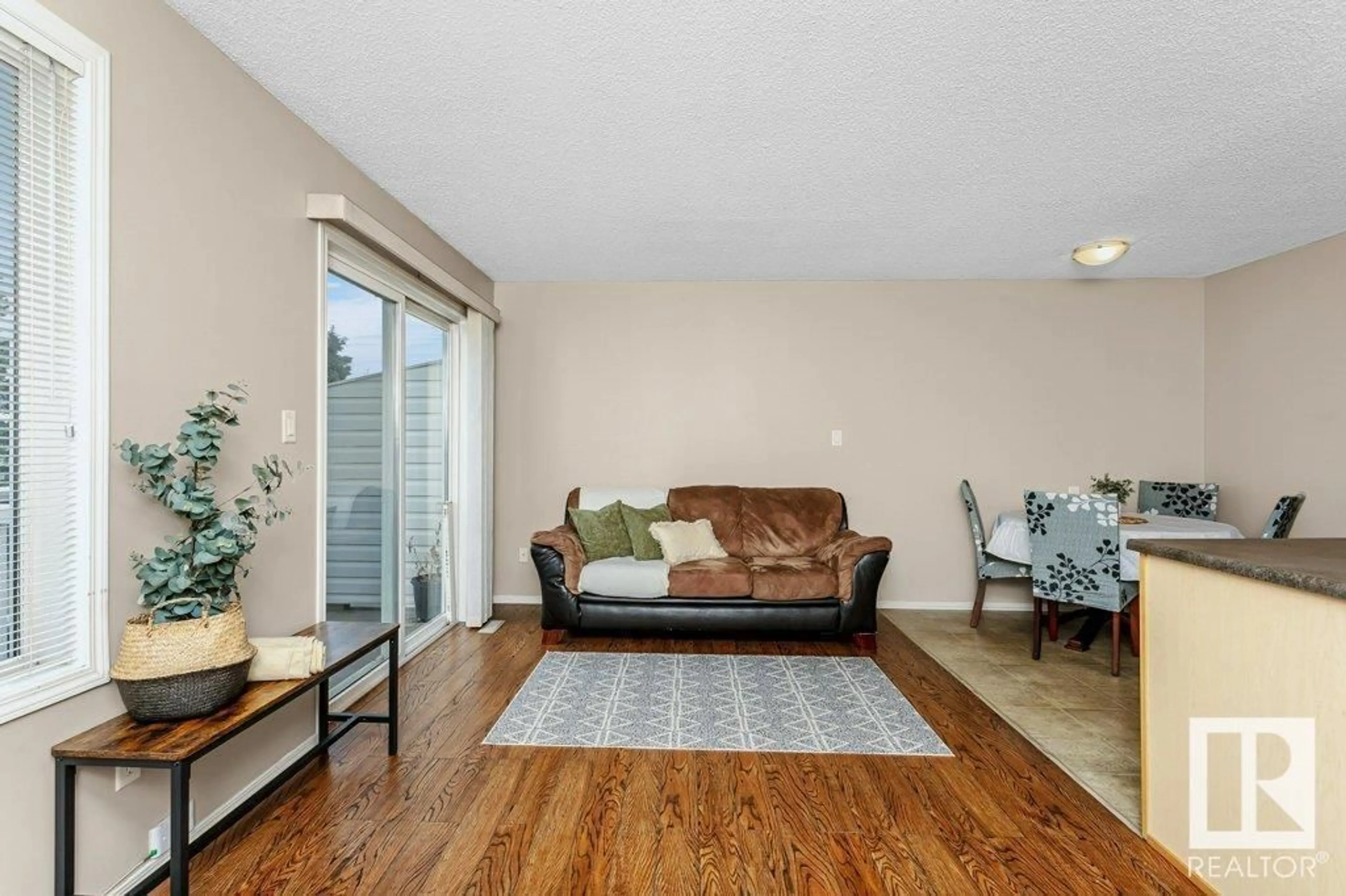 Living room with furniture, wood/laminate floor for 451 - 27 HYNDMAN CR, Edmonton Alberta T5A5J3