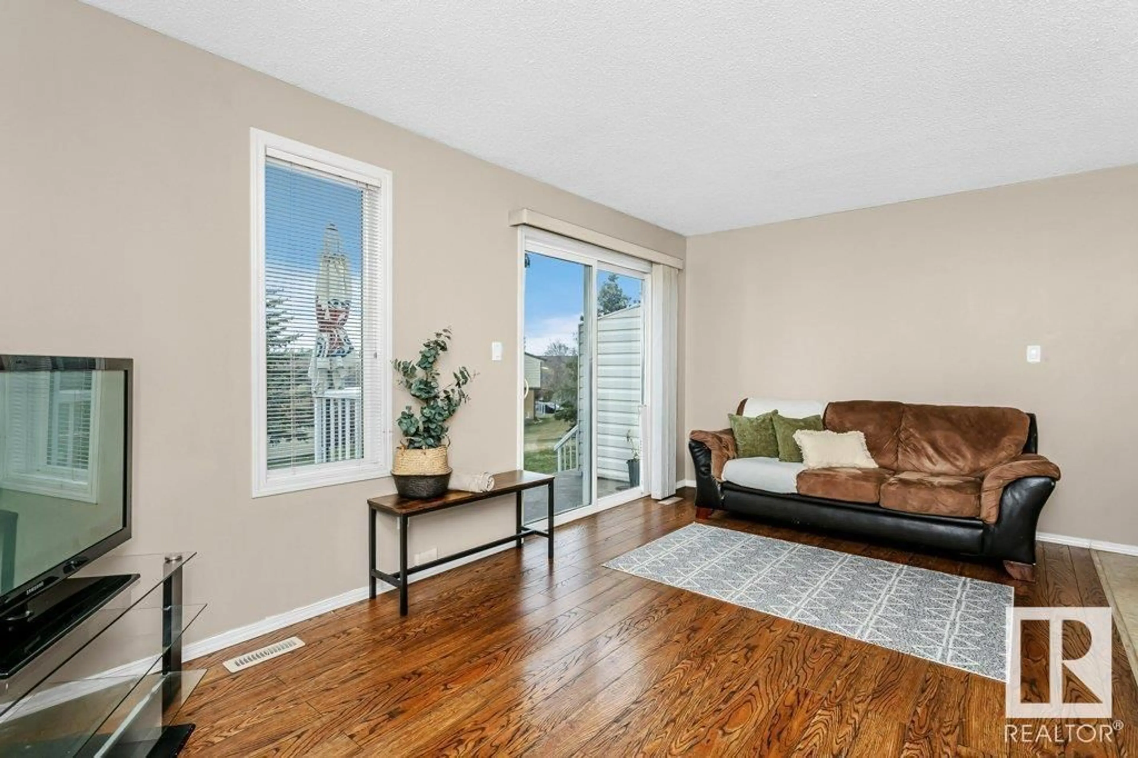 Living room with furniture, wood/laminate floor for 451 - 27 HYNDMAN CR, Edmonton Alberta T5A5J3