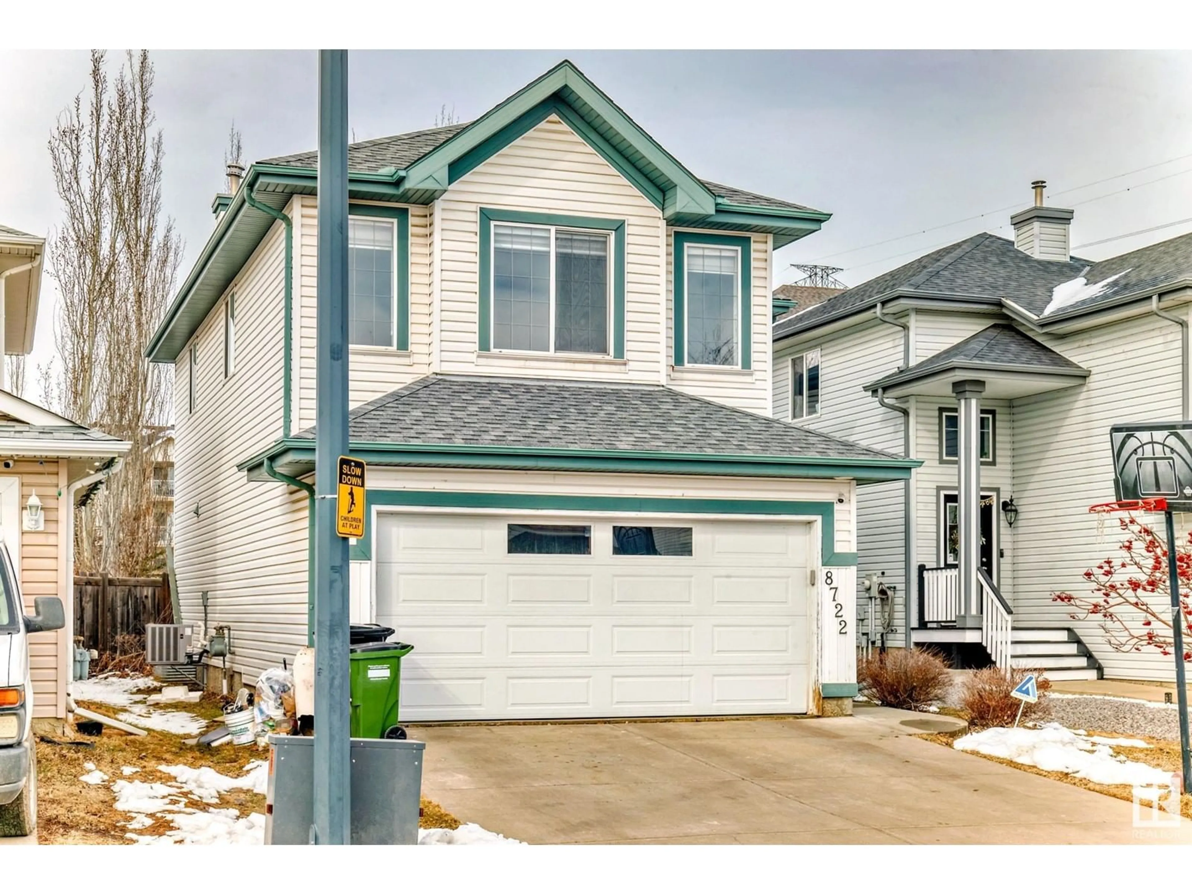 Home with vinyl exterior material, street for 8722 5 AV SW, Edmonton Alberta T6X1E2