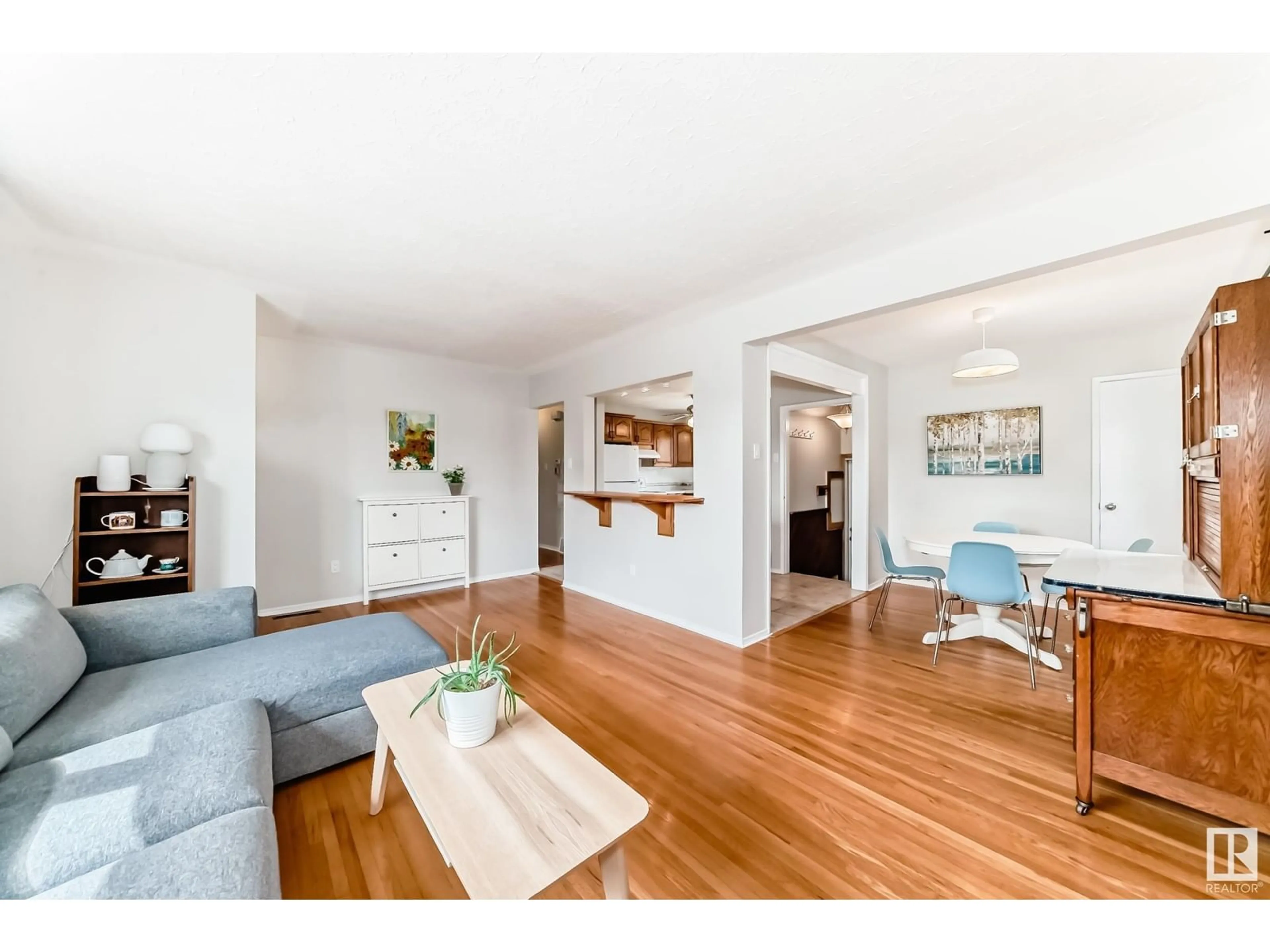 Living room with furniture, wood/laminate floor for 4712 102 AV, Edmonton Alberta T6A0M7