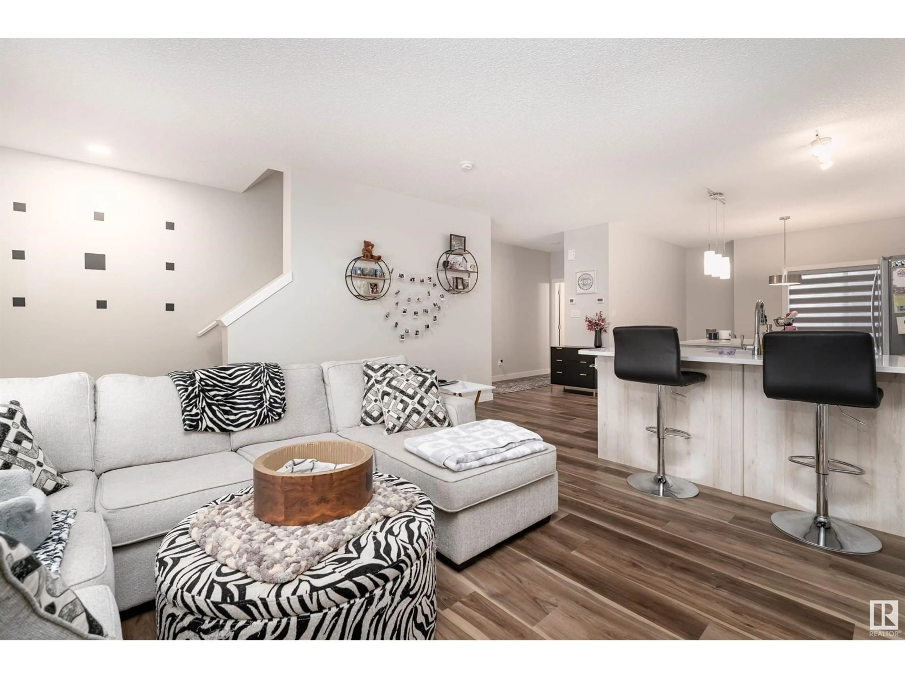 Living room with furniture, wood/laminate floor for 979 - 17 CRYSTALLINA NERA WY, Edmonton Alberta T5Z0S3