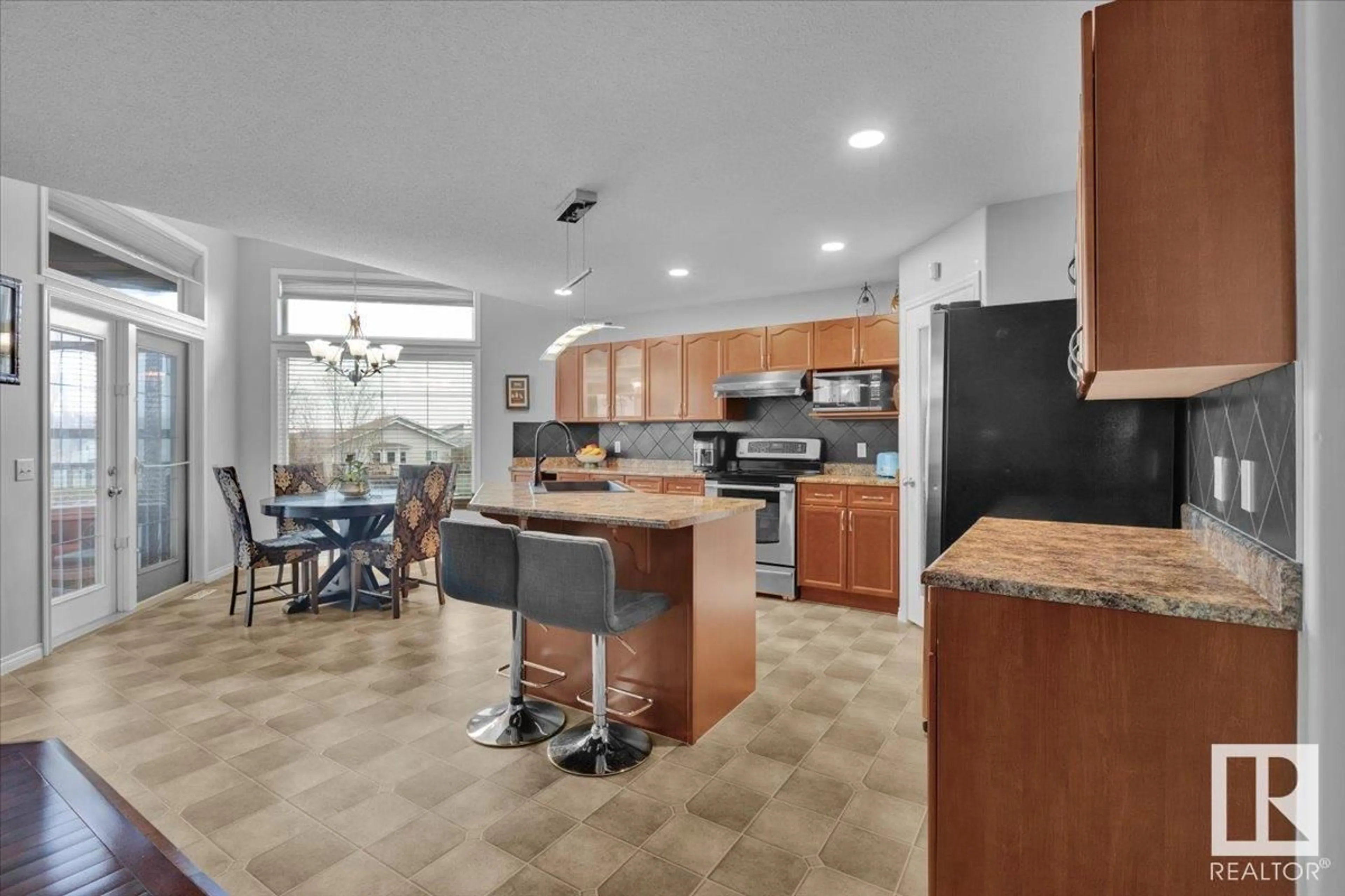 Open concept kitchen, ceramic/tile floor for 6443 164 AV, Edmonton Alberta T5Y3J2