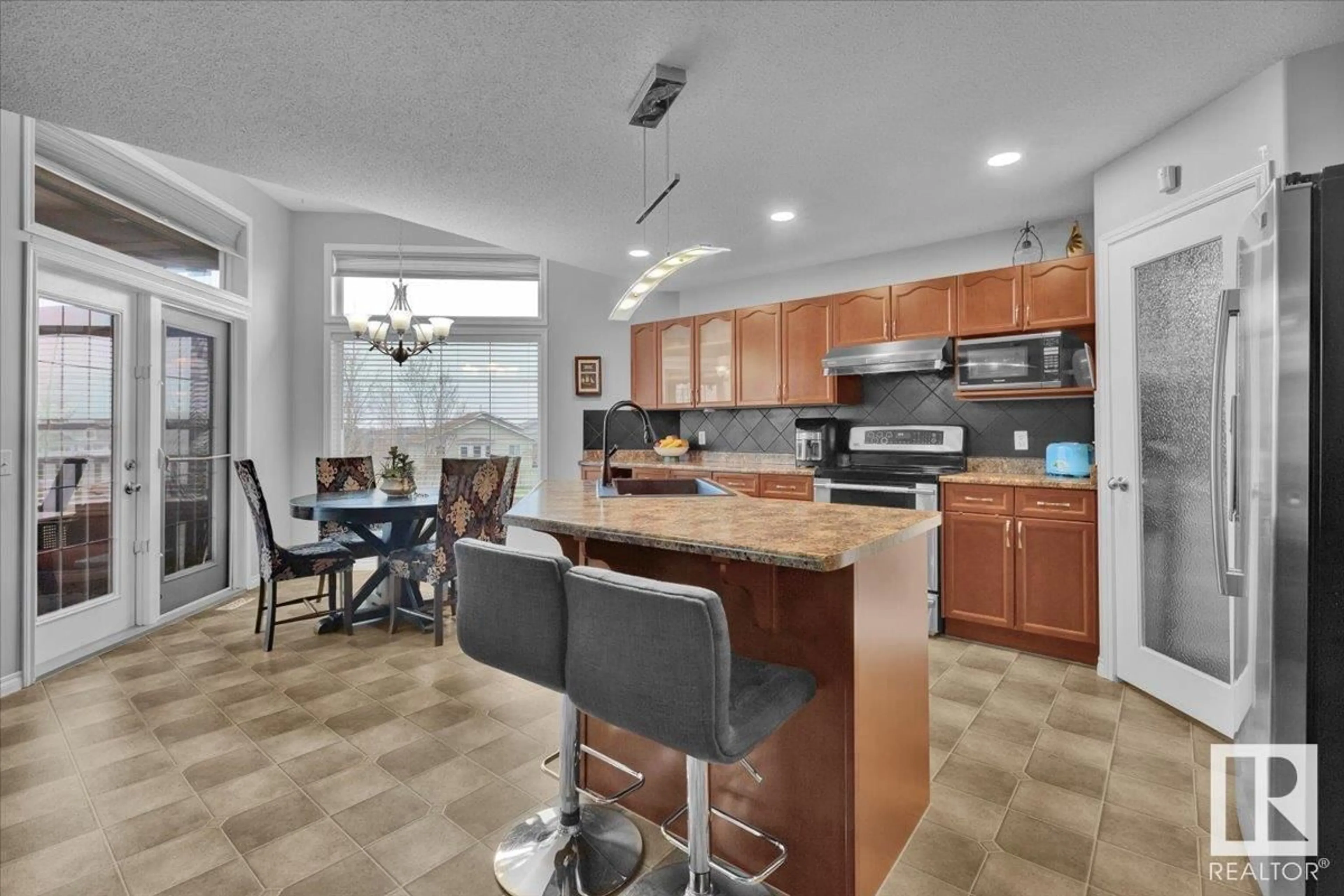 Open concept kitchen, ceramic/tile floor for 6443 164 AV, Edmonton Alberta T5Y3J2