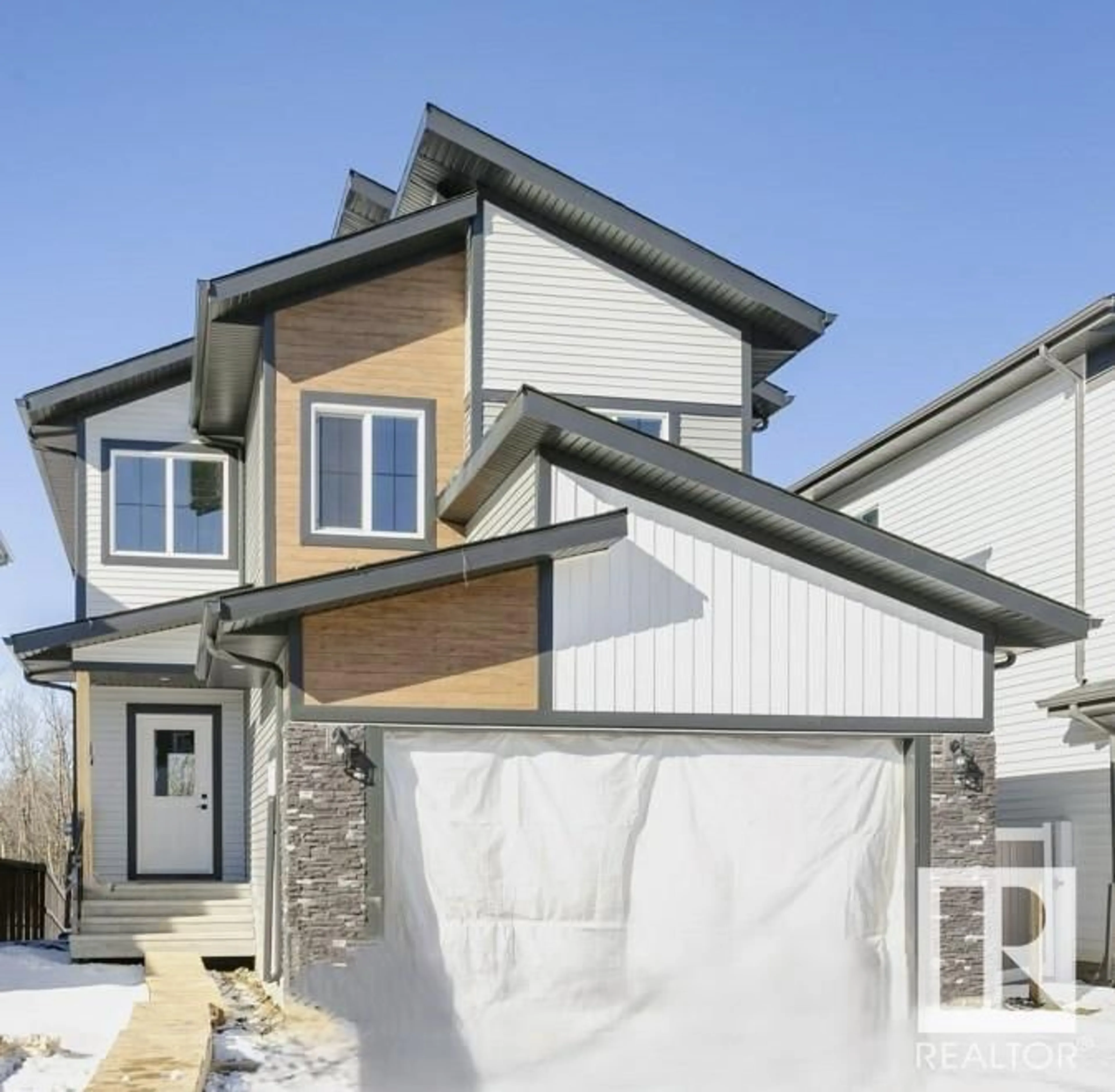 Home with vinyl exterior material, street for 100 MILLER WD, Leduc Alberta T4N1R7