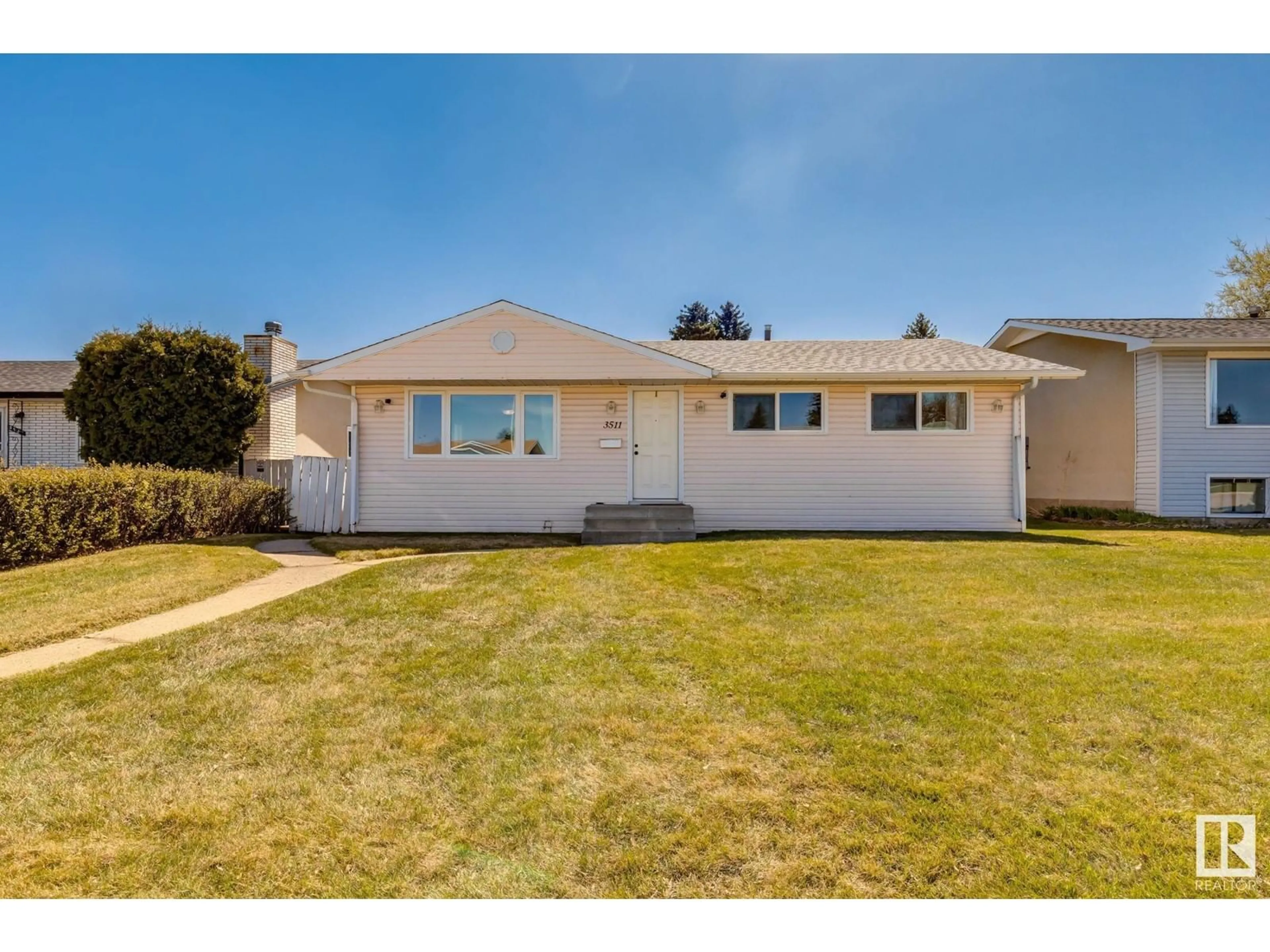 Home with vinyl exterior material, street for 3511 105 AV, Edmonton Alberta T5W0B6