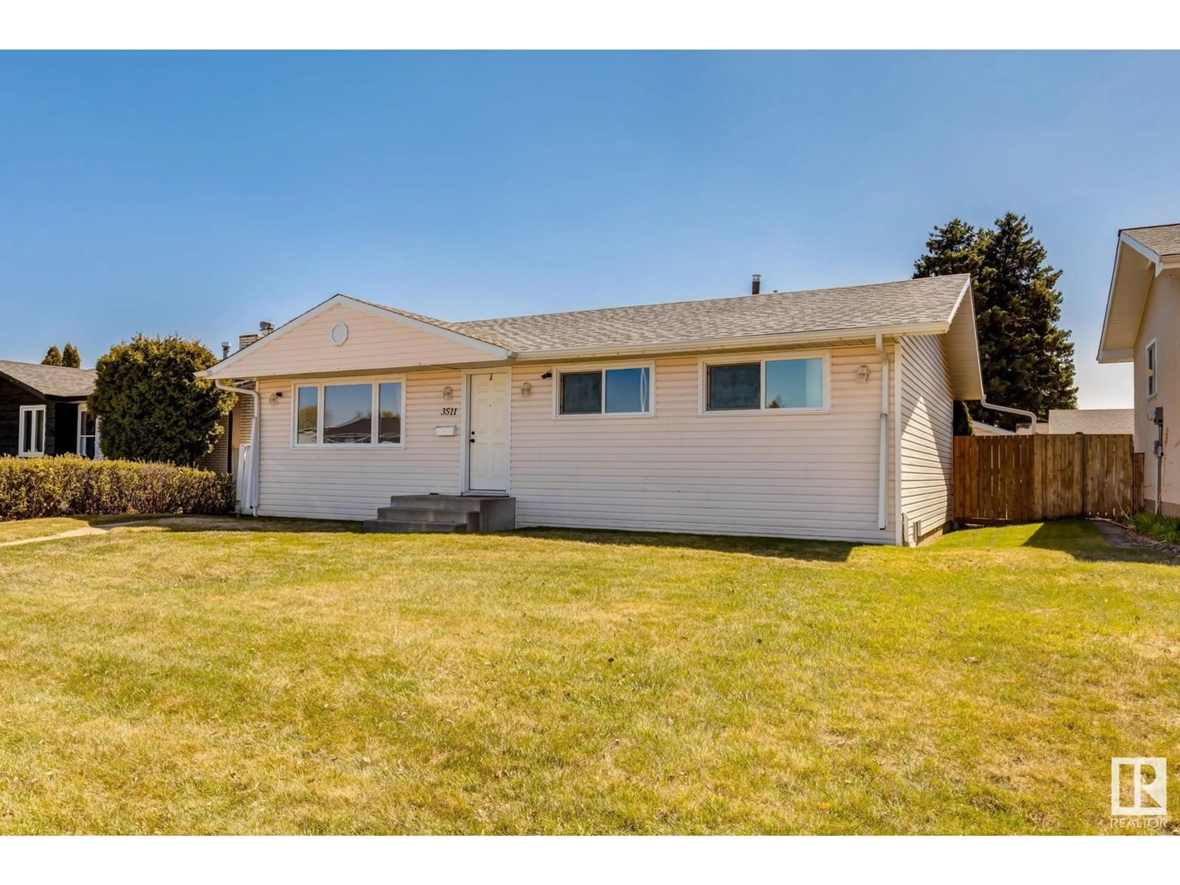 Home with vinyl exterior material, street for 3511 105 AV, Edmonton Alberta T5W0B6