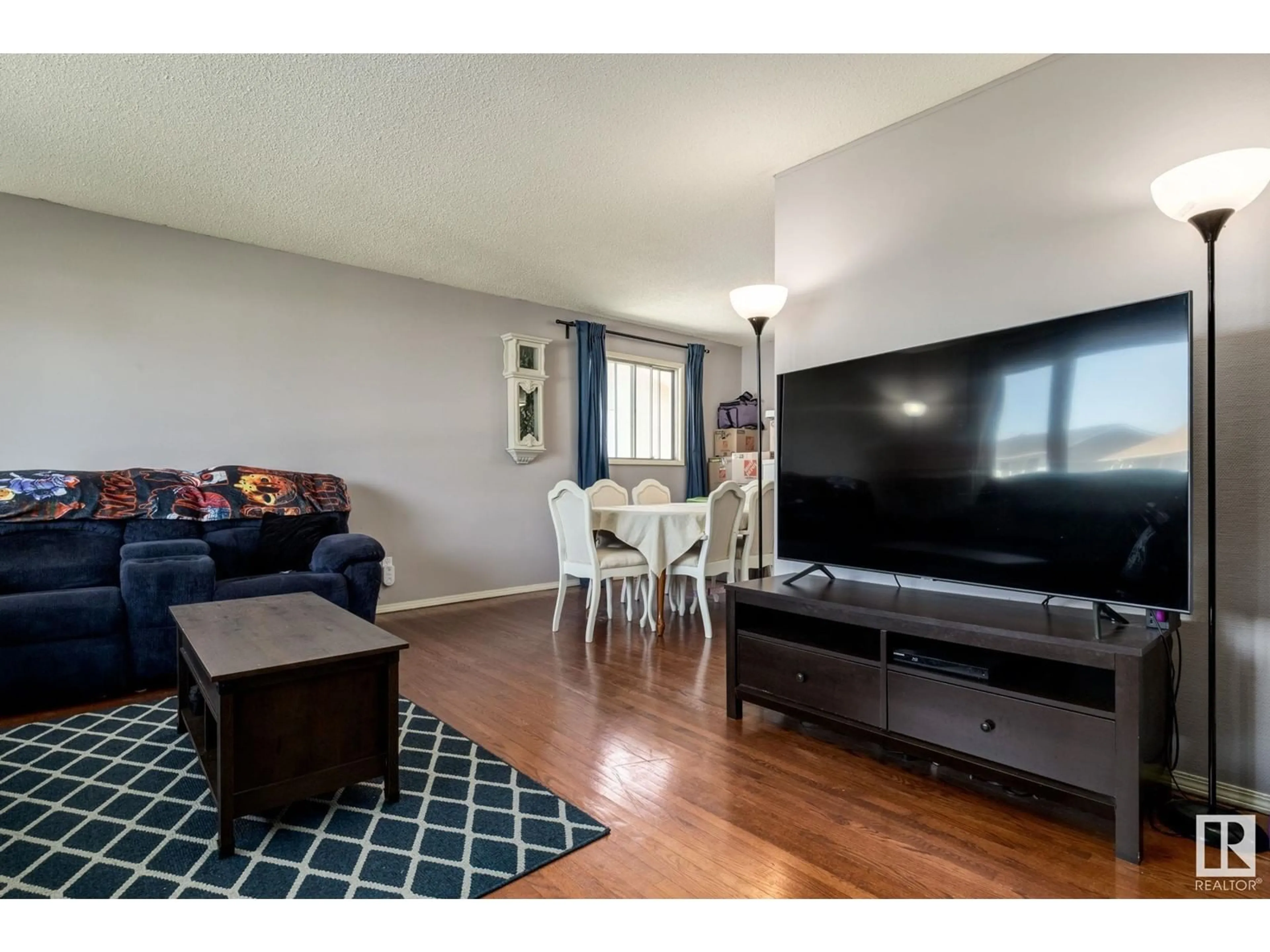 Living room with furniture, wood/laminate floor for 3511 105 AV, Edmonton Alberta T5W0B6