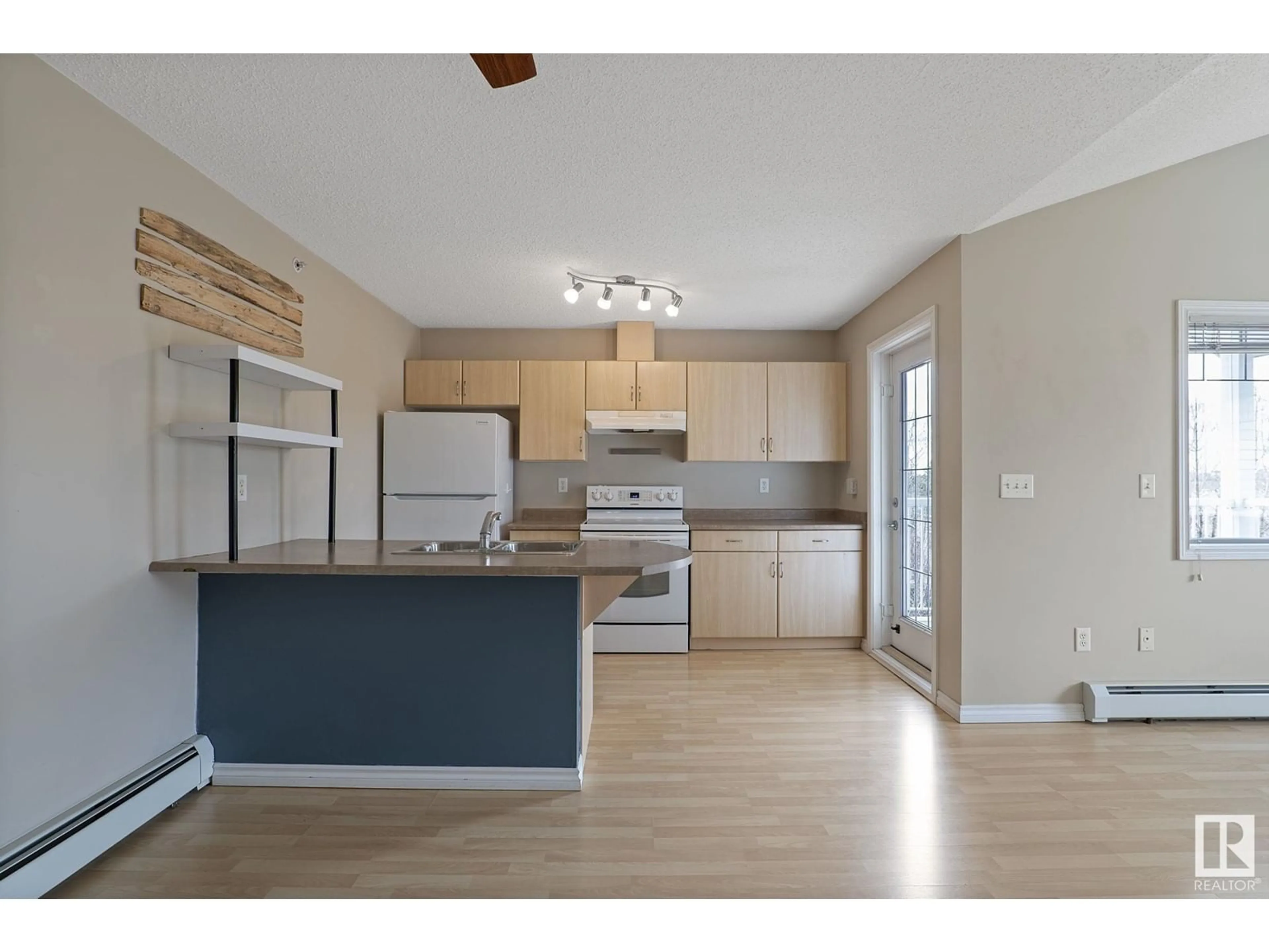 Open concept kitchen, wood/laminate floor for 905 - 314 BLACKLOCK WY, Edmonton Alberta T6W1M7