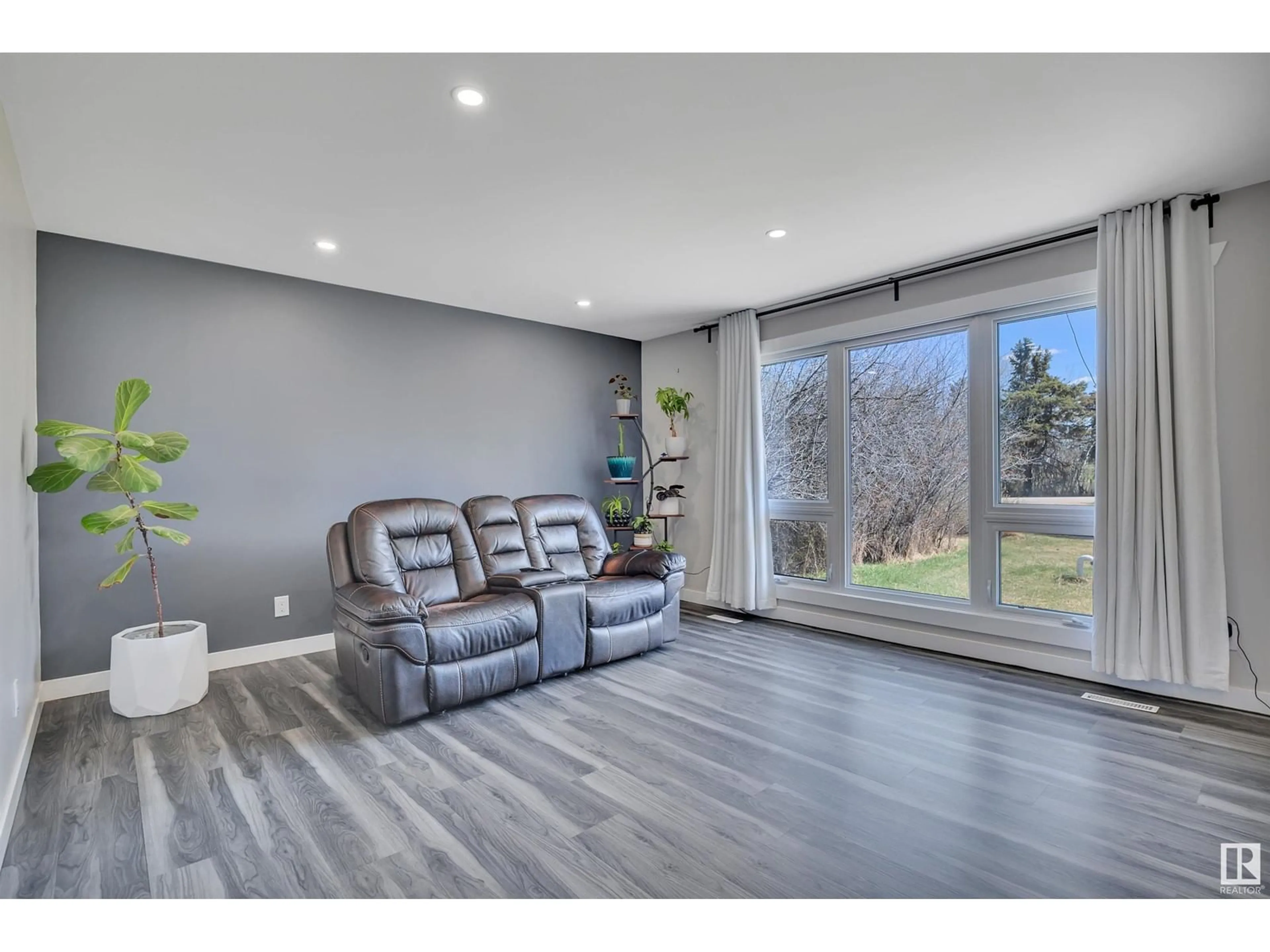 Living room with furniture, wood/laminate floor for 54178 RGE ROAD 220, Rural Strathcona County Alberta T8L3Y7