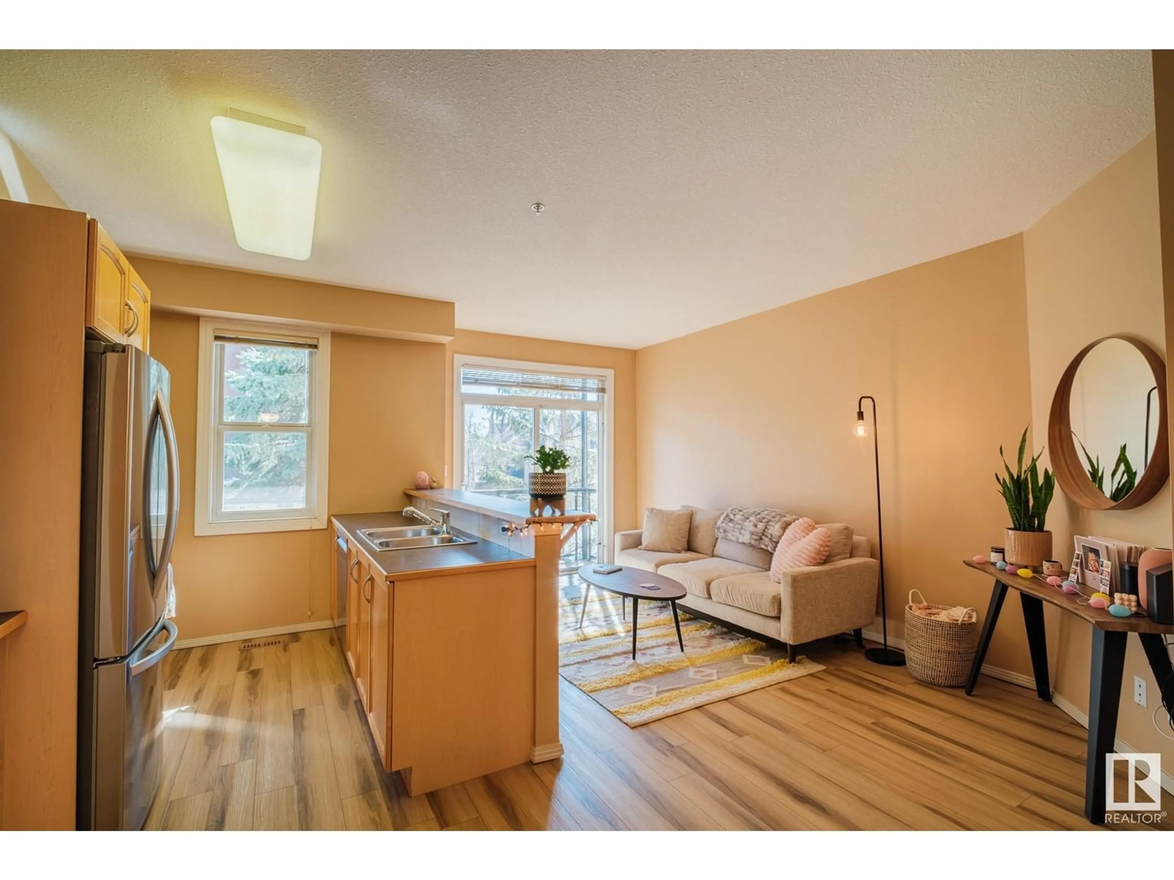 Living room with furniture, wood/laminate floor for 205 8619 111 ST NW, Edmonton Alberta T6W2W1