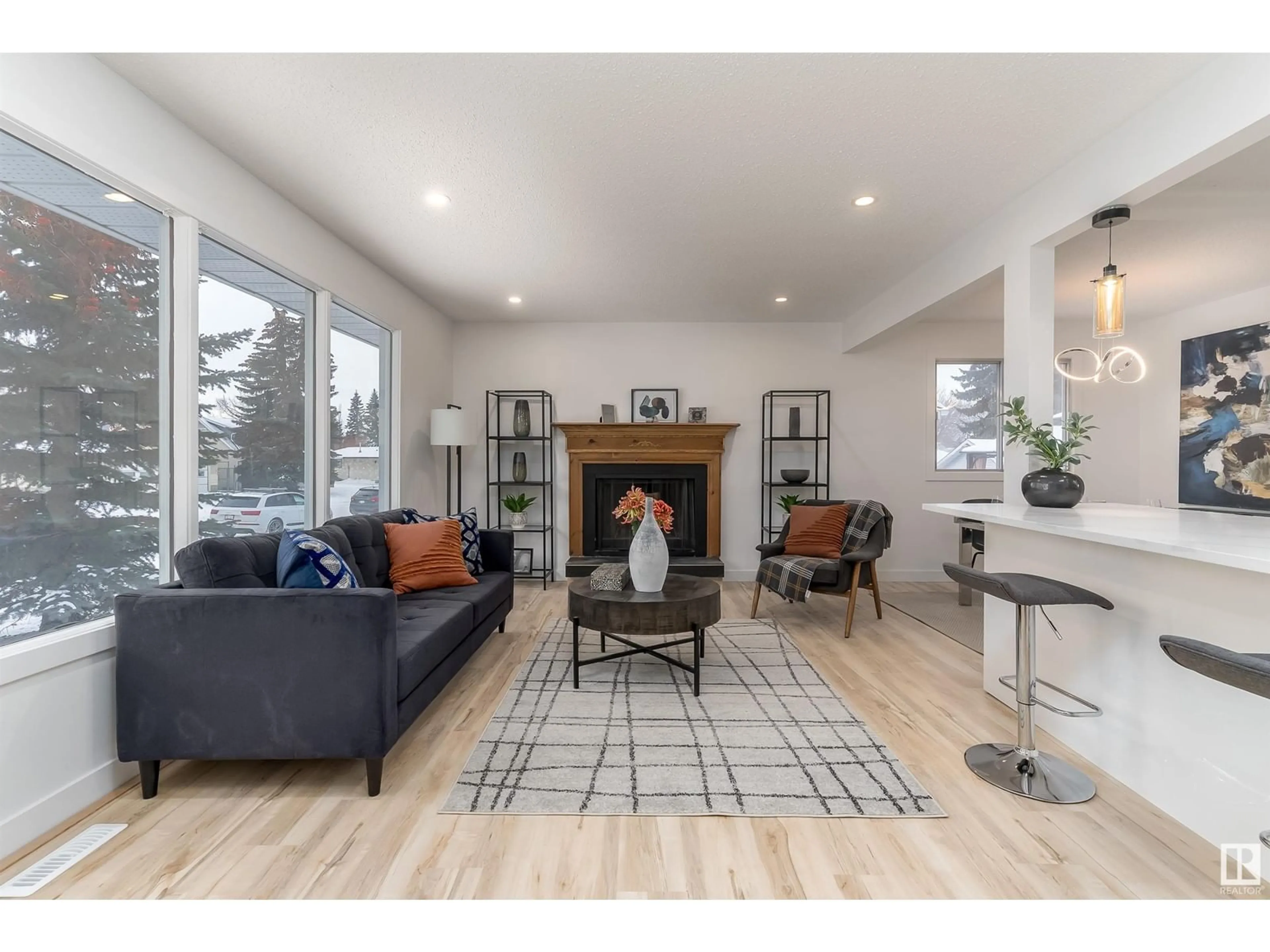 Living room with furniture, wood/laminate floor for 8104 17 AV, Edmonton Alberta T6K2C8