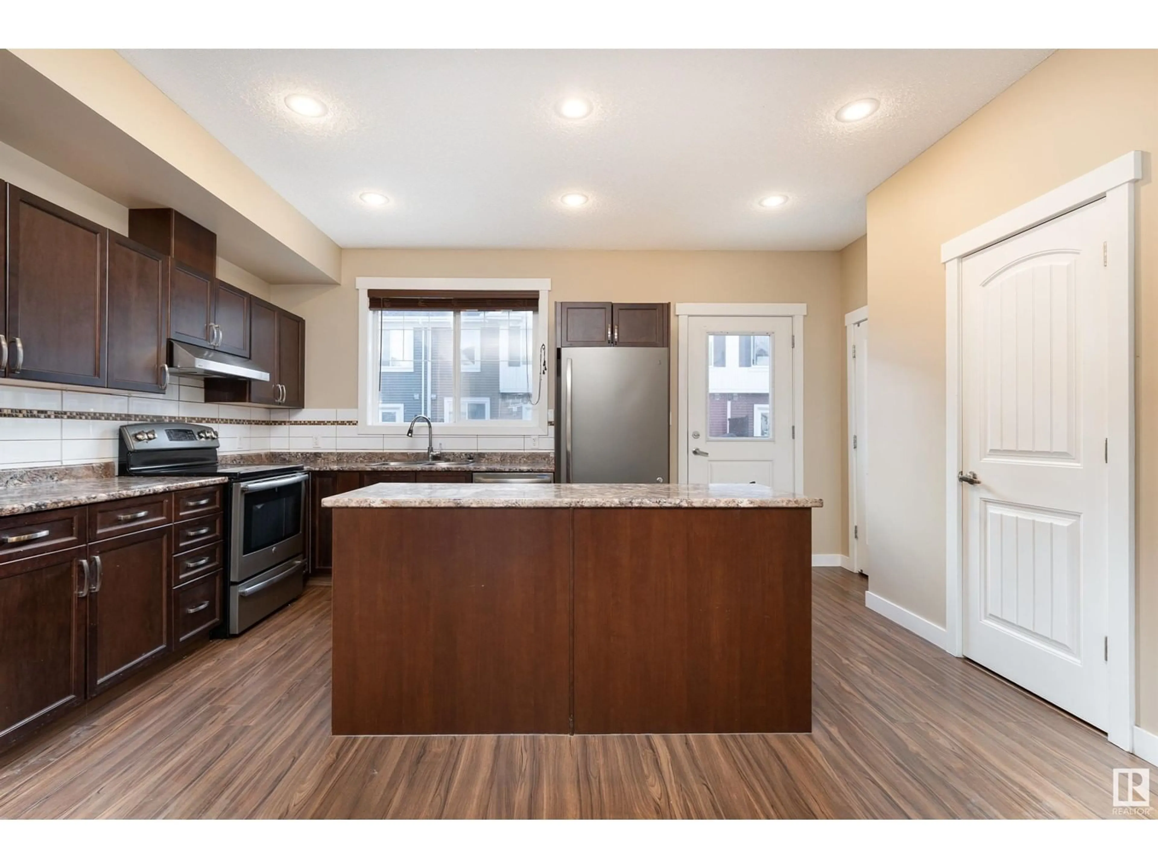 Open concept kitchen, wood/laminate floor for 74 - 8315 180 AV NW, Edmonton Alberta T6X0Y2