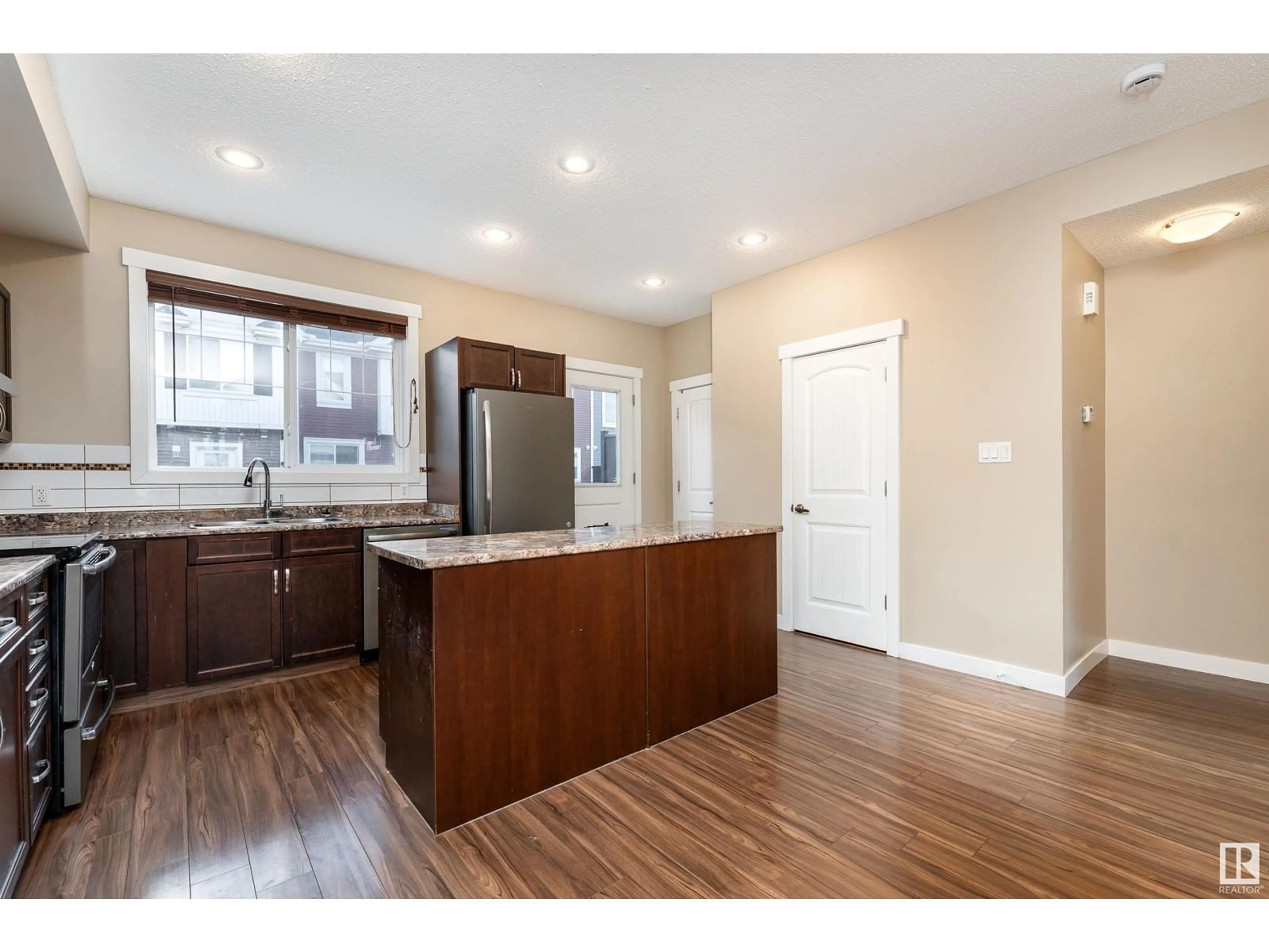 Open concept kitchen, wood/laminate floor for 74 - 8315 180 AV NW, Edmonton Alberta T6X0Y2