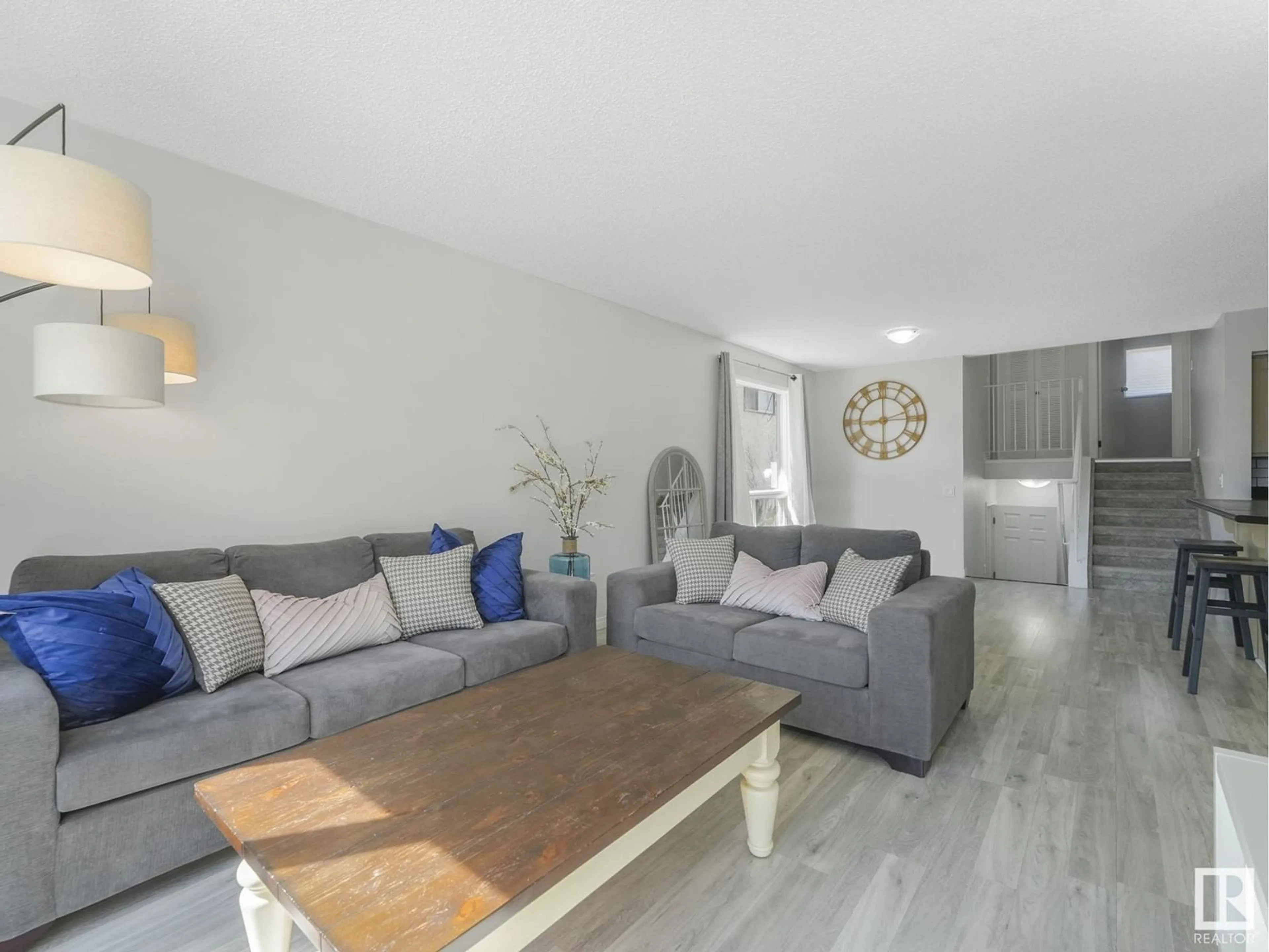 Living room with furniture, wood/laminate floor for 3604 17 AV, Edmonton Alberta T6L2N6