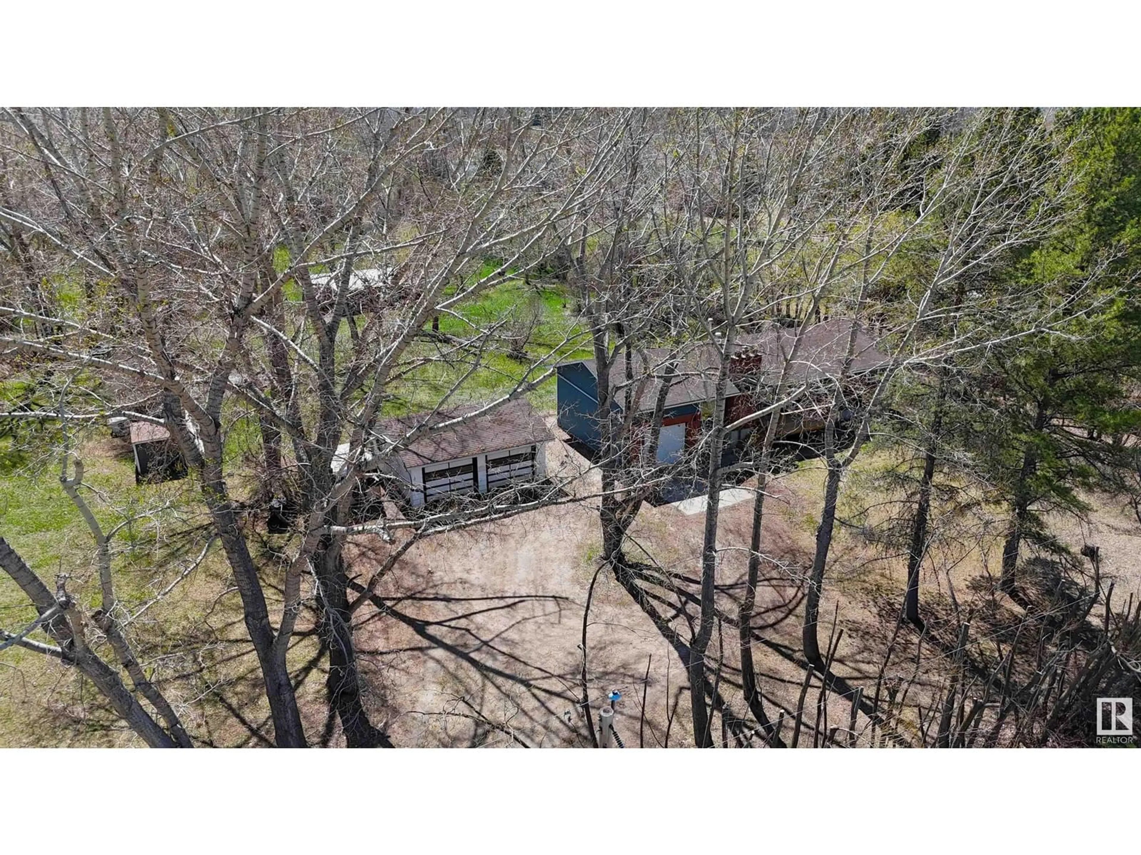 A pic from outside/outdoor area/front of a property/back of a property/a pic from drone, forest/trees view for 17 - 53219 RGE ROAD 271, Rural Parkland County Alberta T7X3L9