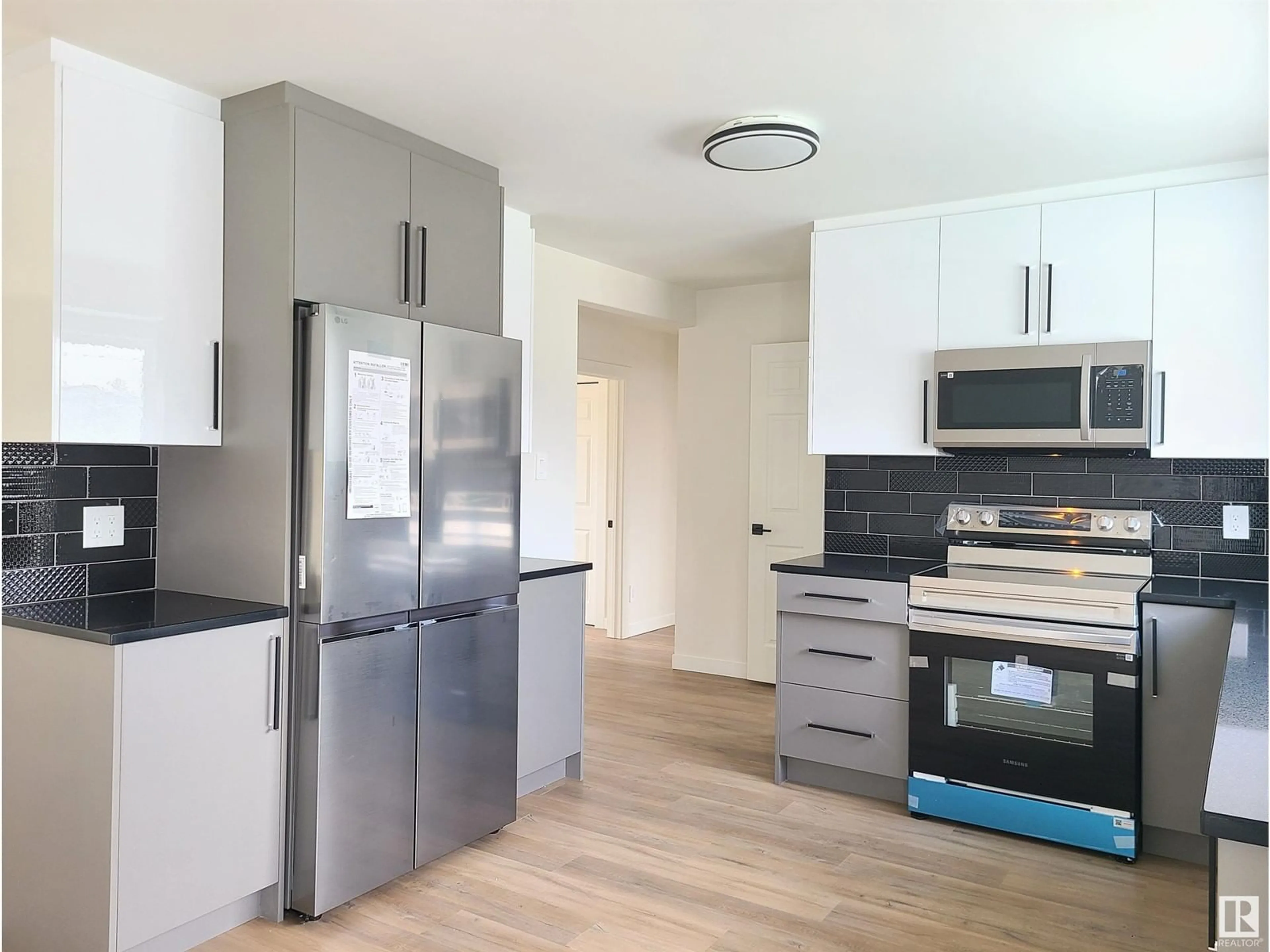 Open concept kitchen, wood/laminate floor for NW - 12904 93 ST, Edmonton Alberta T5E3T2