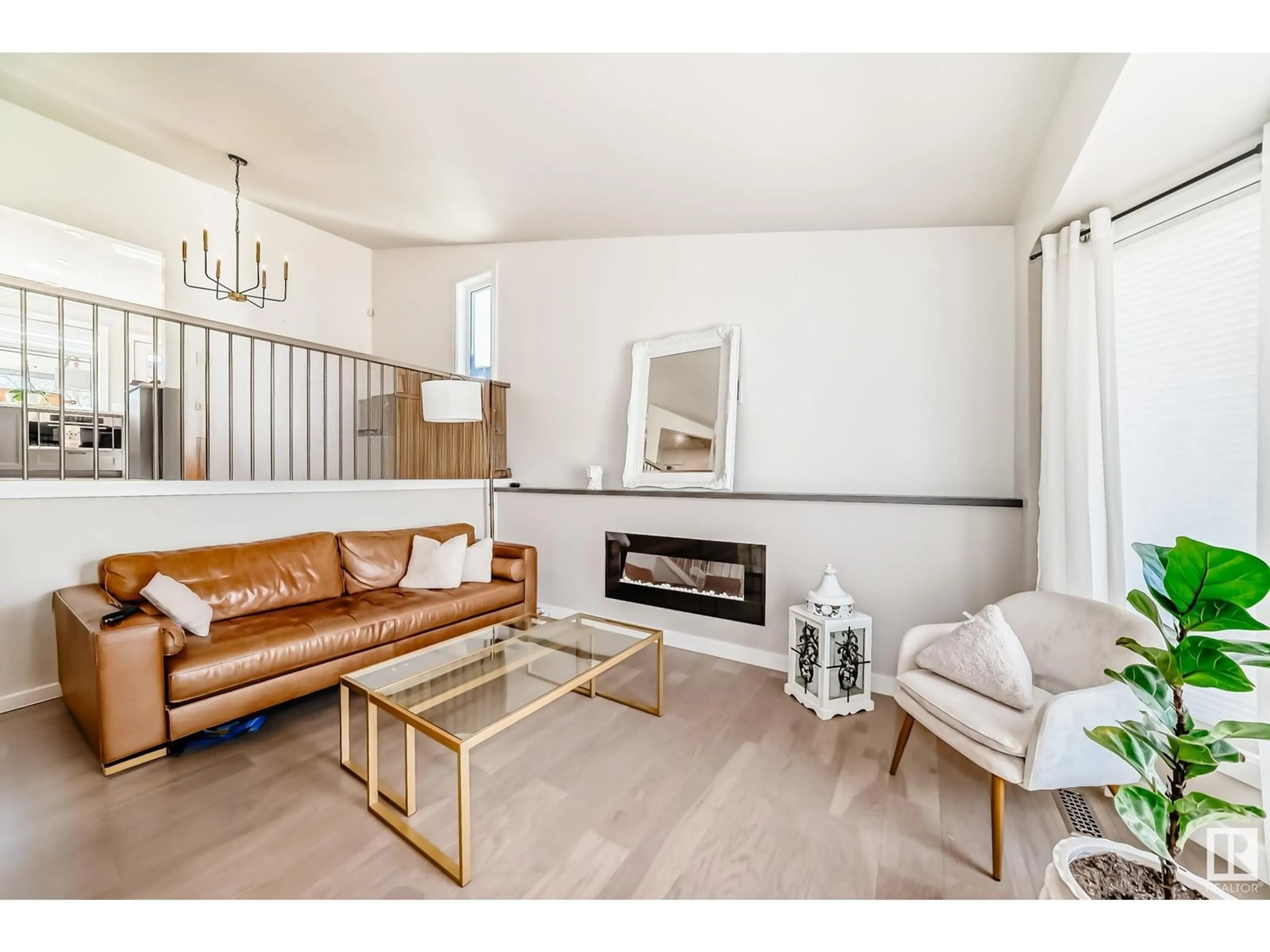 Living room with furniture, wood/laminate floor for 7727 152B AV, Edmonton Alberta T5C3M3