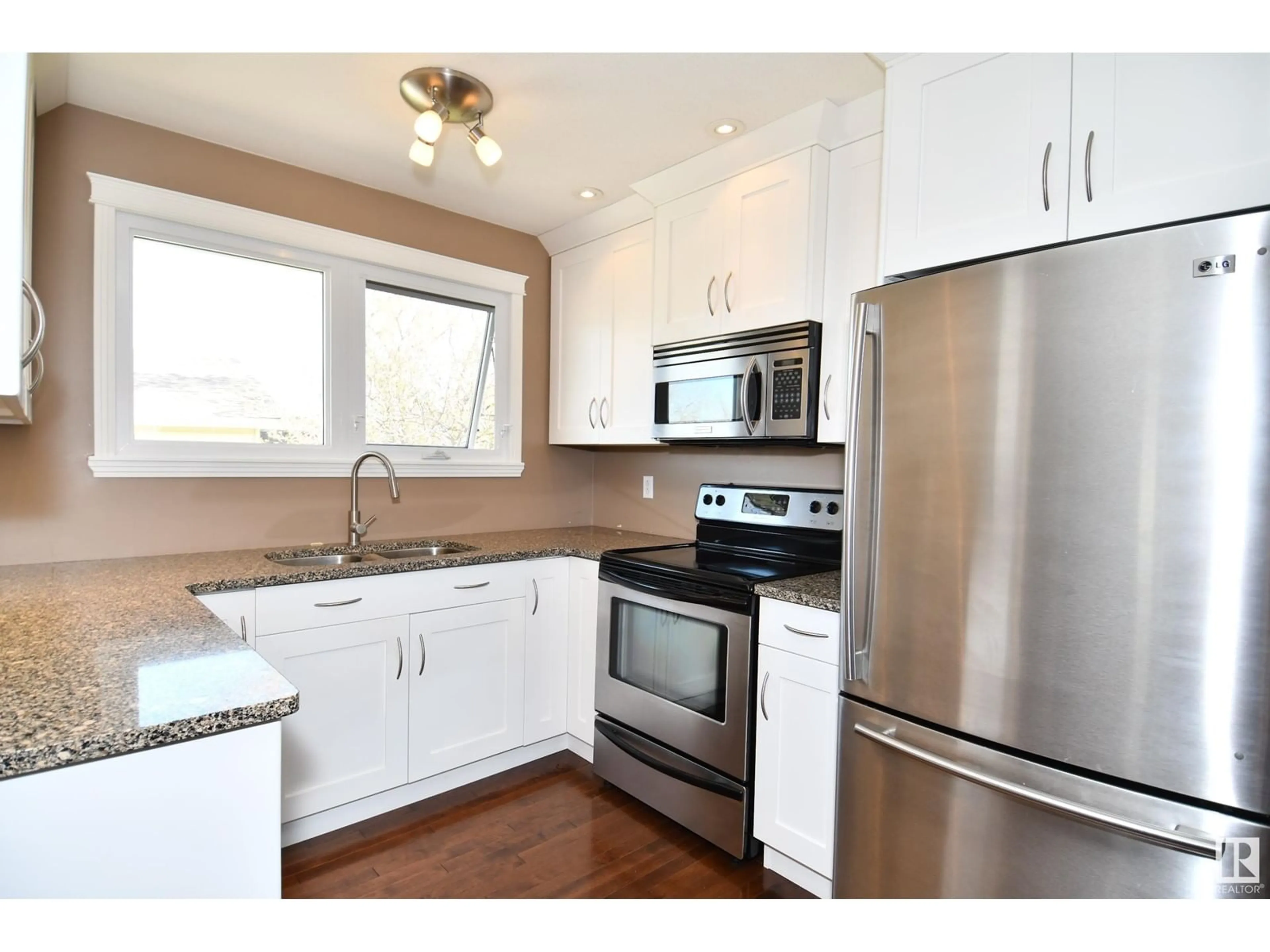 Open concept kitchen, wood/laminate floor for 4310 36 AV, Leduc Alberta T9E6A2