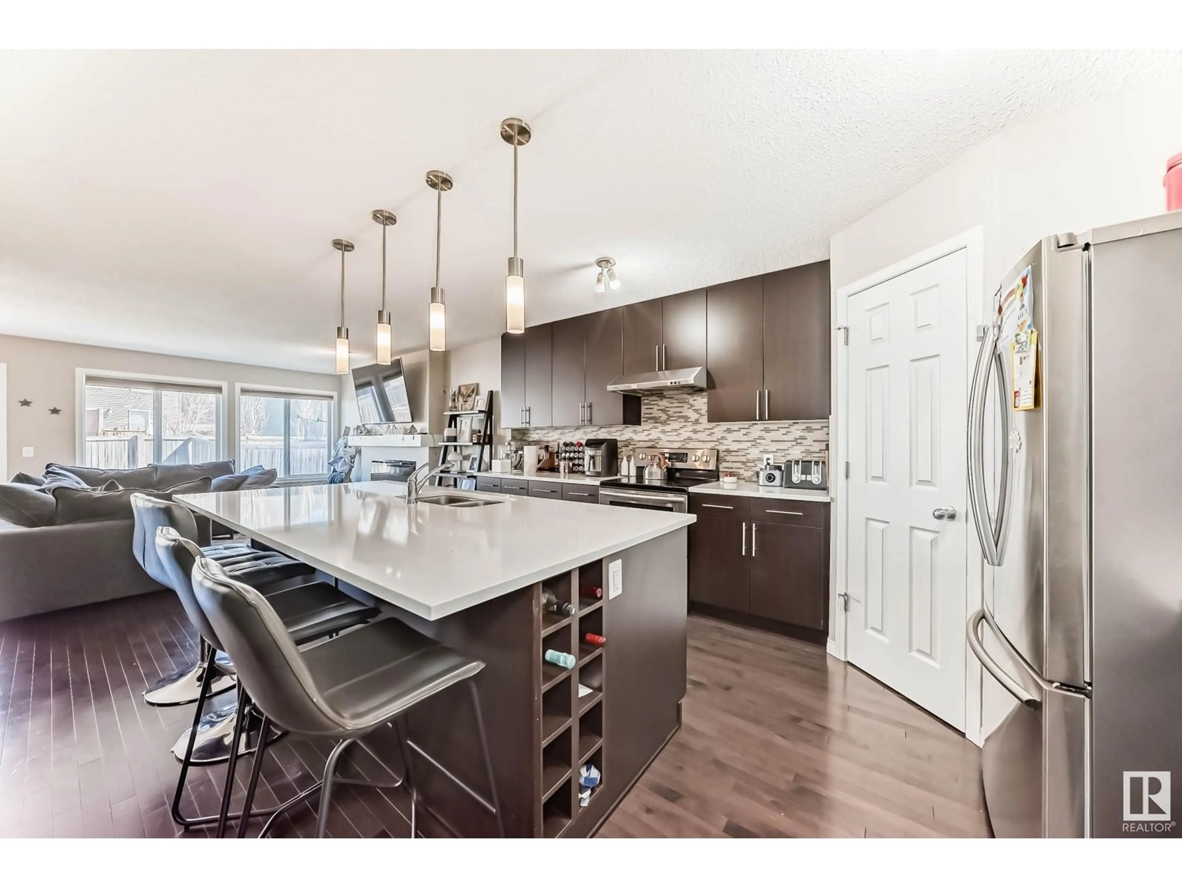 Open concept kitchen, wood/laminate floor for 2317 76 ST, Edmonton Alberta T6X1S6