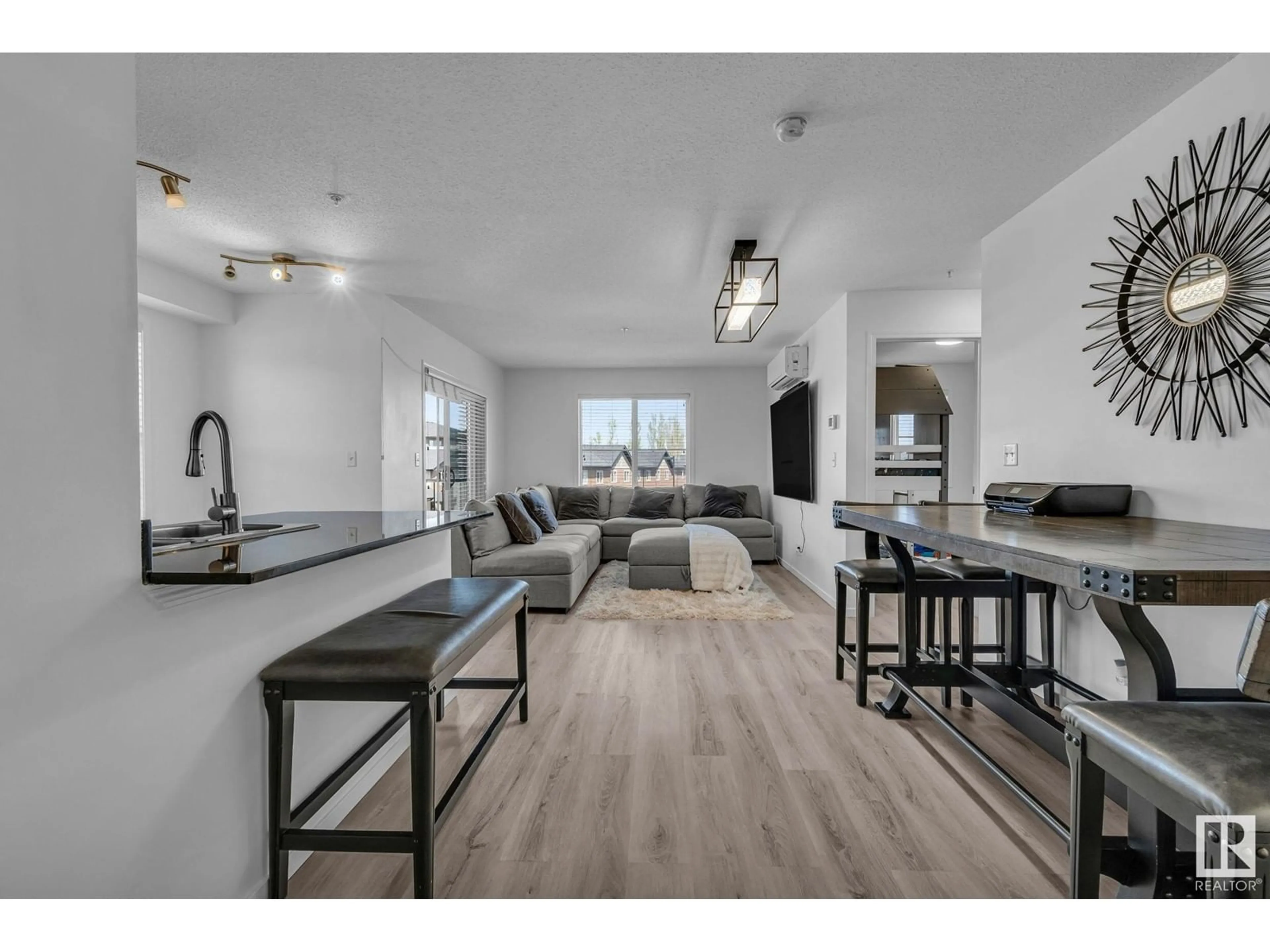 Open concept kitchen, wood/laminate floor for 302 12025 22 AVE SW, Edmonton Alberta T6W2Y1