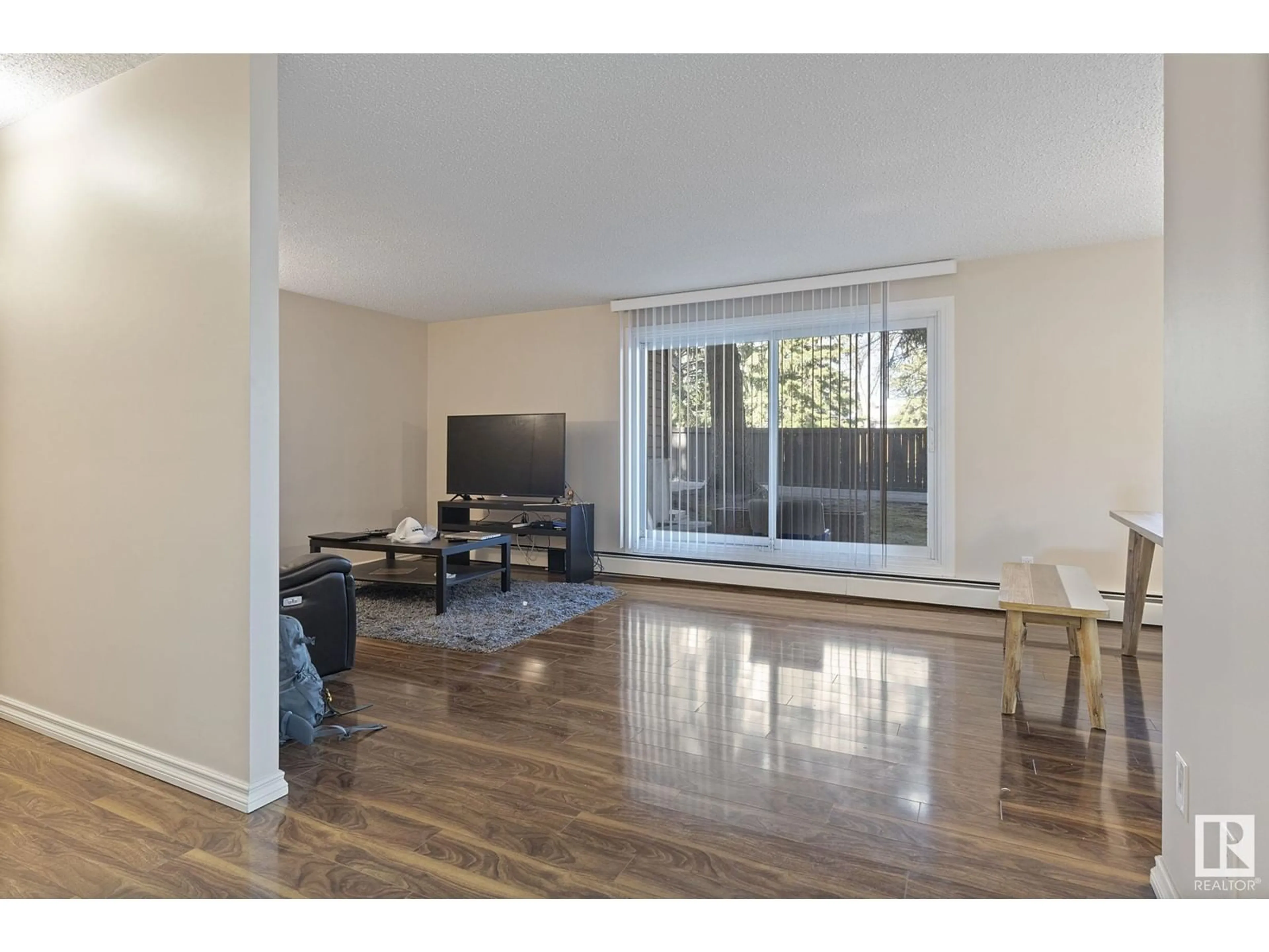 Living room with furniture, wood/laminate floor for #109 - 5520 RIVERBEND RD, Edmonton Alberta T6H5G9