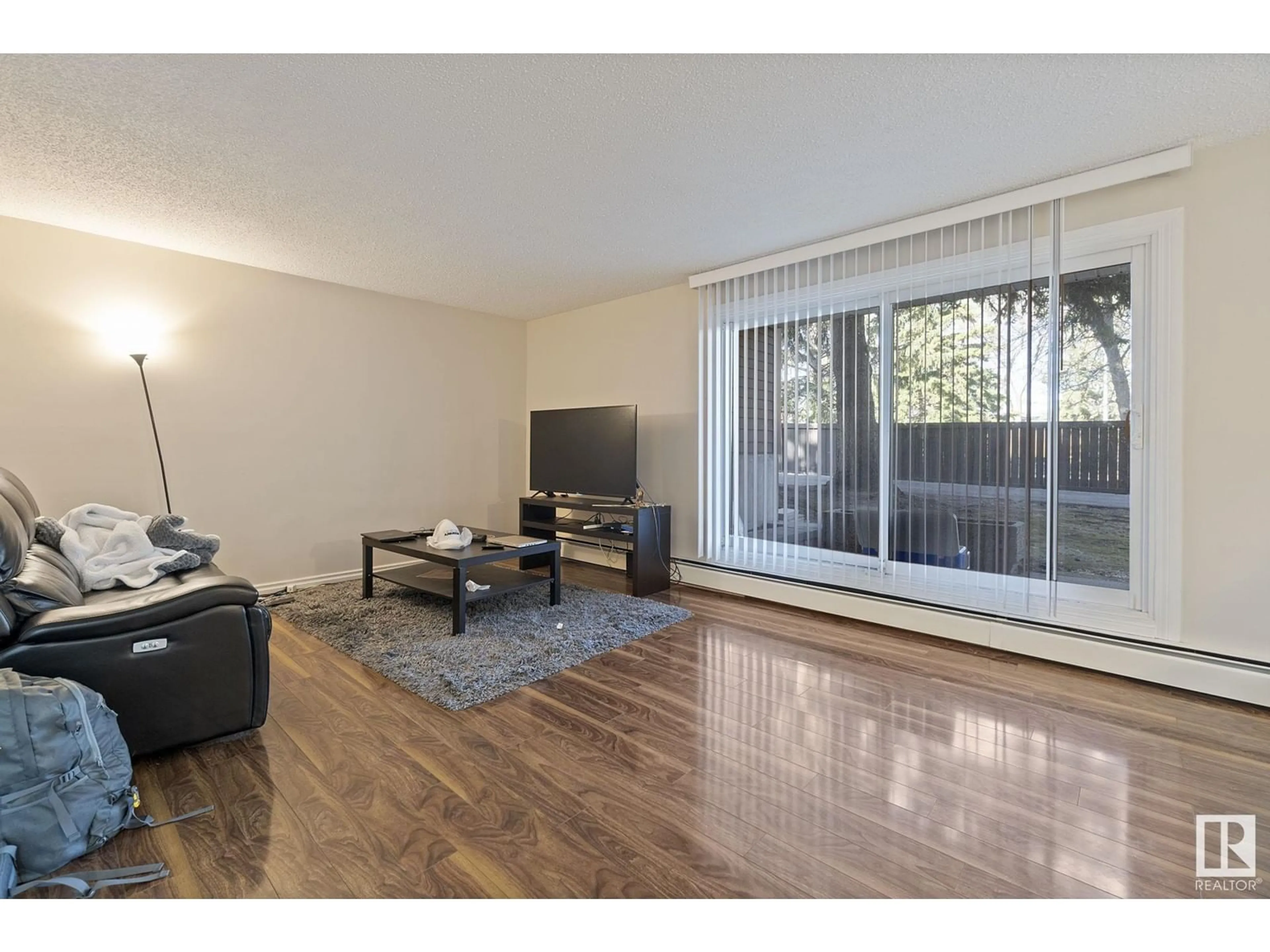 Living room with furniture, wood/laminate floor for #109 - 5520 RIVERBEND RD, Edmonton Alberta T6H5G9