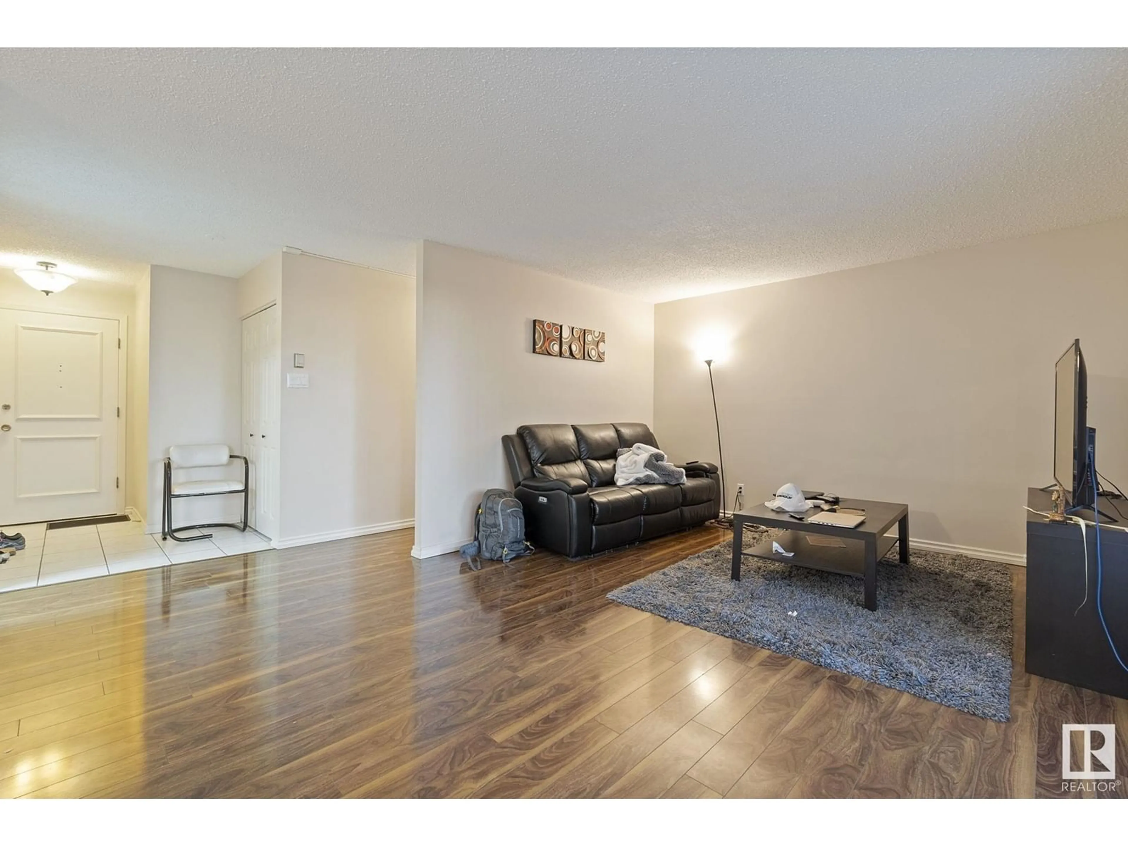 Living room with furniture, wood/laminate floor for #109 - 5520 RIVERBEND RD, Edmonton Alberta T6H5G9