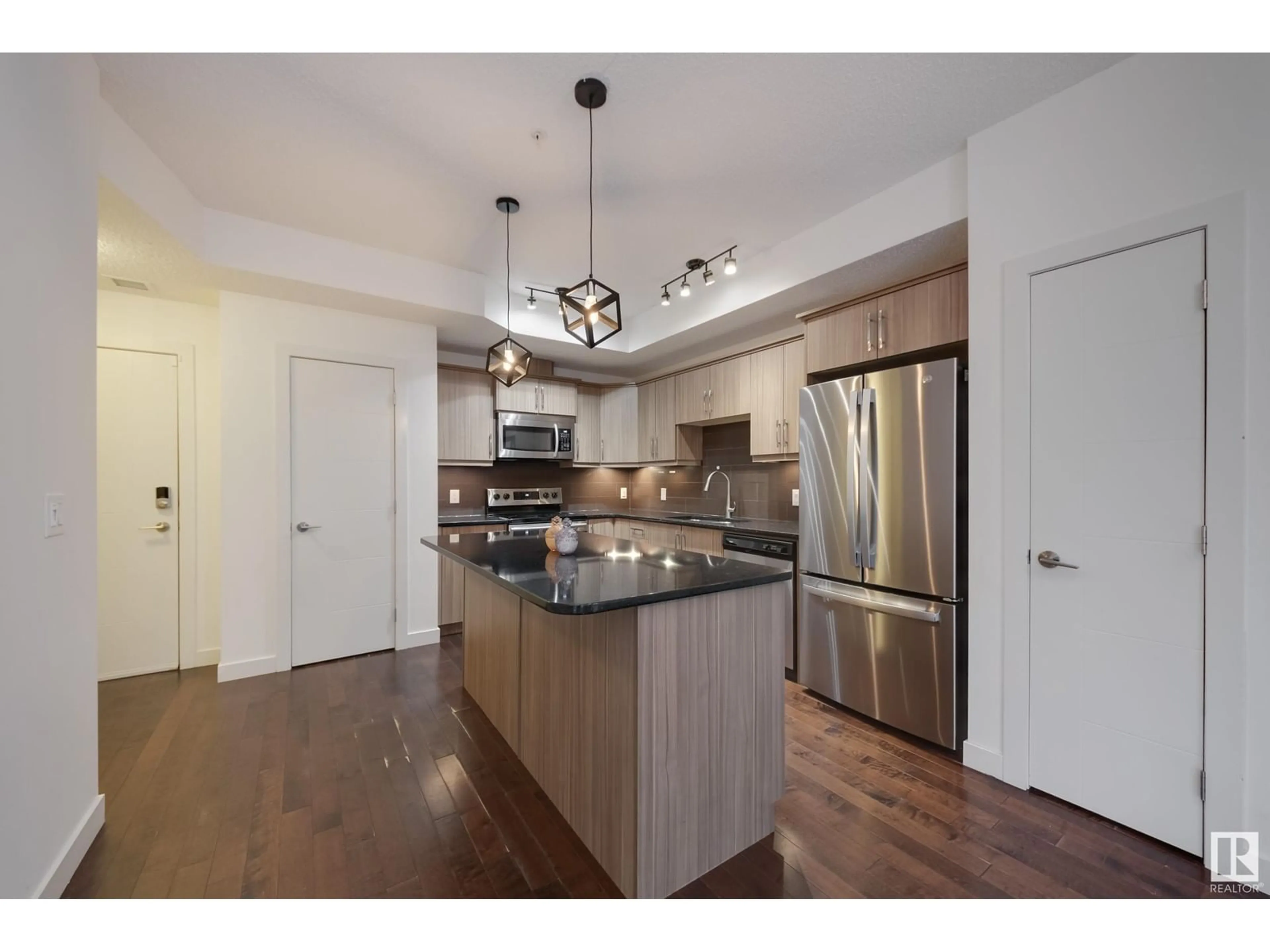 Open concept kitchen, wood/laminate floor for #115 - 10523 123 ST, Edmonton Alberta T5N1N9