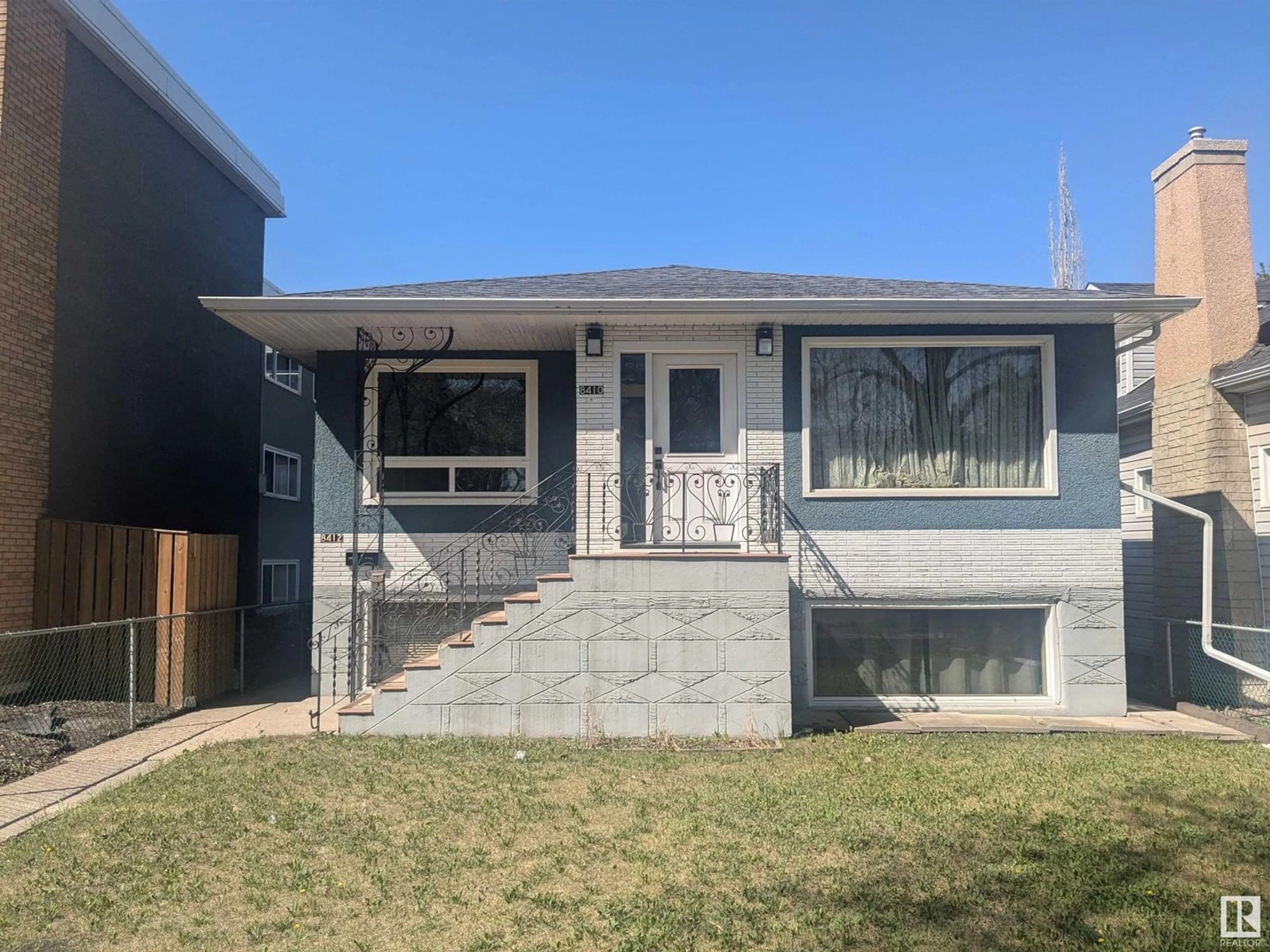 Home with vinyl exterior material, street for NW - 8410/8412 104 ST, Edmonton Alberta T6E4G2