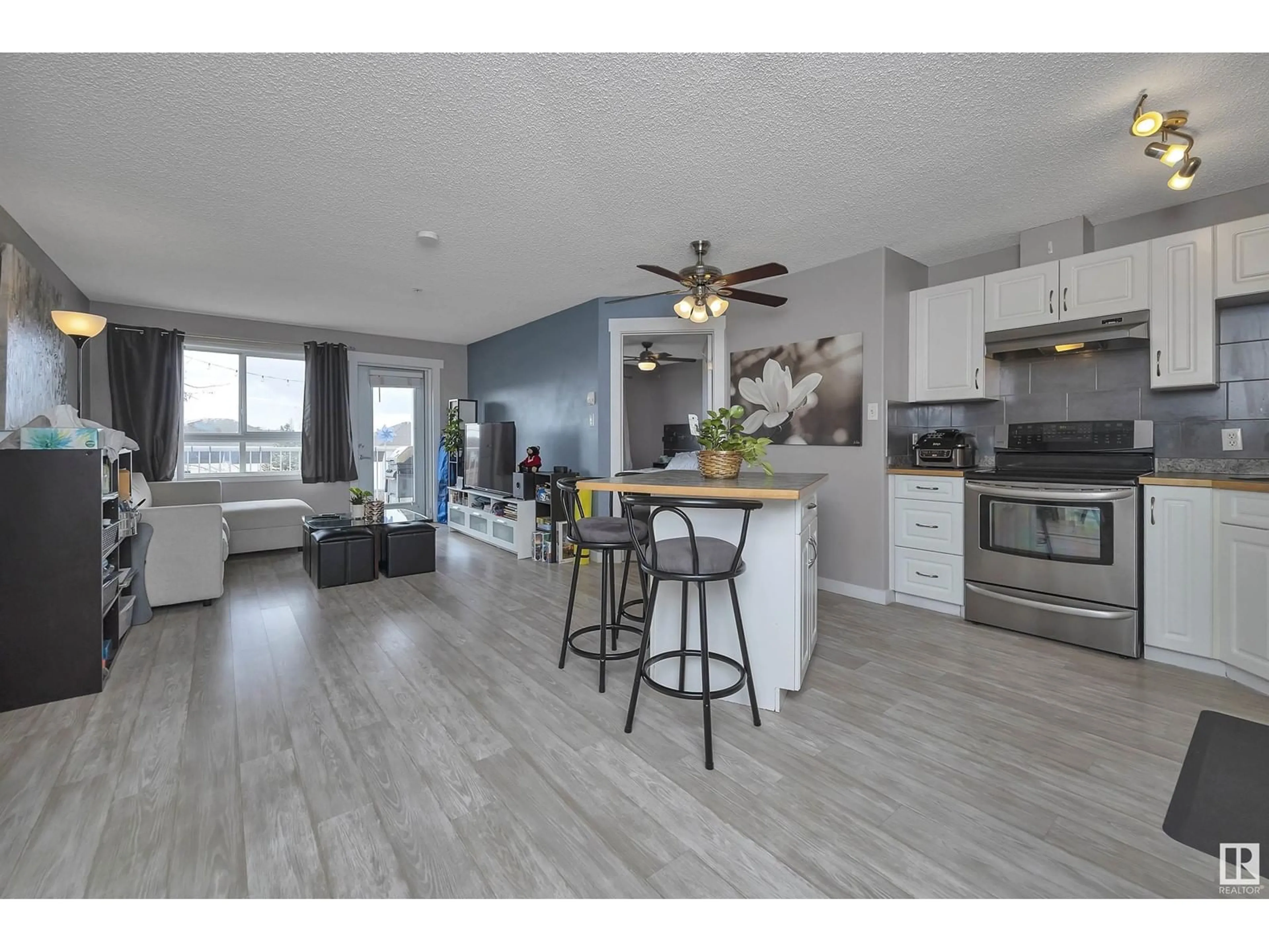 Open concept kitchen, wood/laminate floor for #310 - 5350 199 ST, Edmonton Alberta T6M0A4