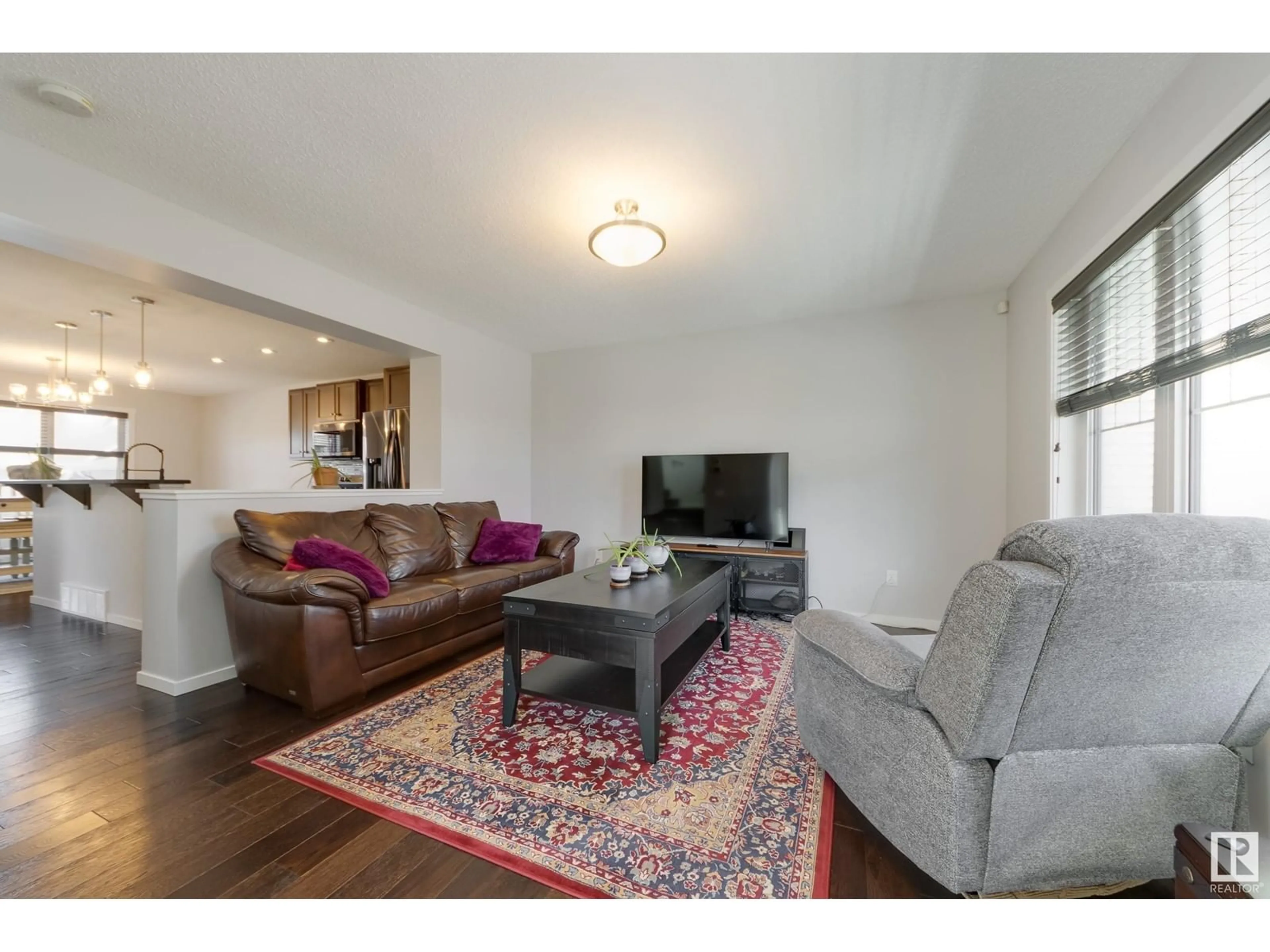 Living room with furniture, wood/laminate floor for 840 37 AV NW, Edmonton Alberta T6T0S3