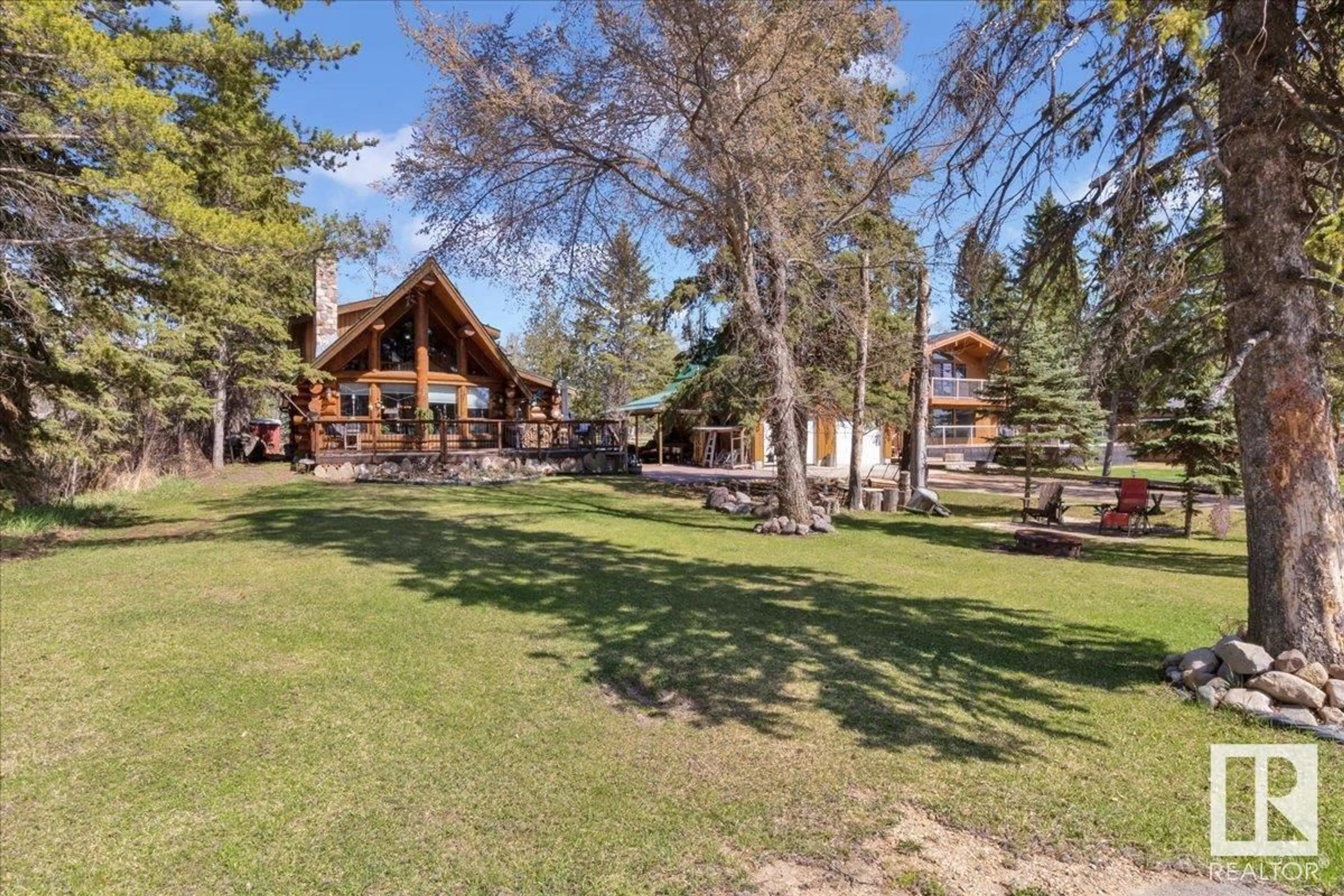 A pic from outside/outdoor area/front of a property/back of a property/a pic from drone, unknown for 5214 LAKE DR, Rural Wetaskiwin County Alberta T0C2C0
