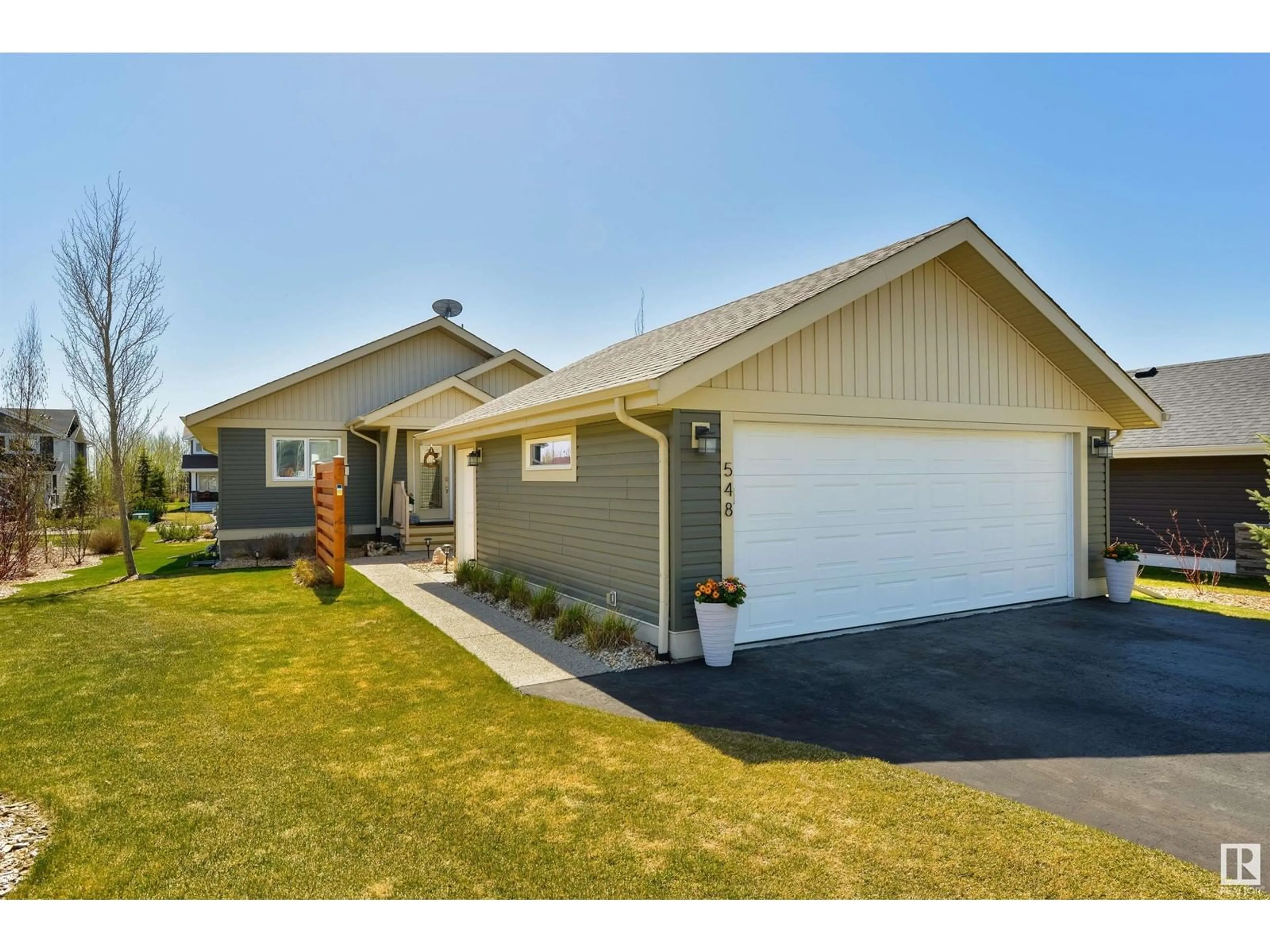 Home with vinyl exterior material, street for 548 55101 STE. ANNE TR, Rural Lac Ste. Anne County Alberta T0E1A1