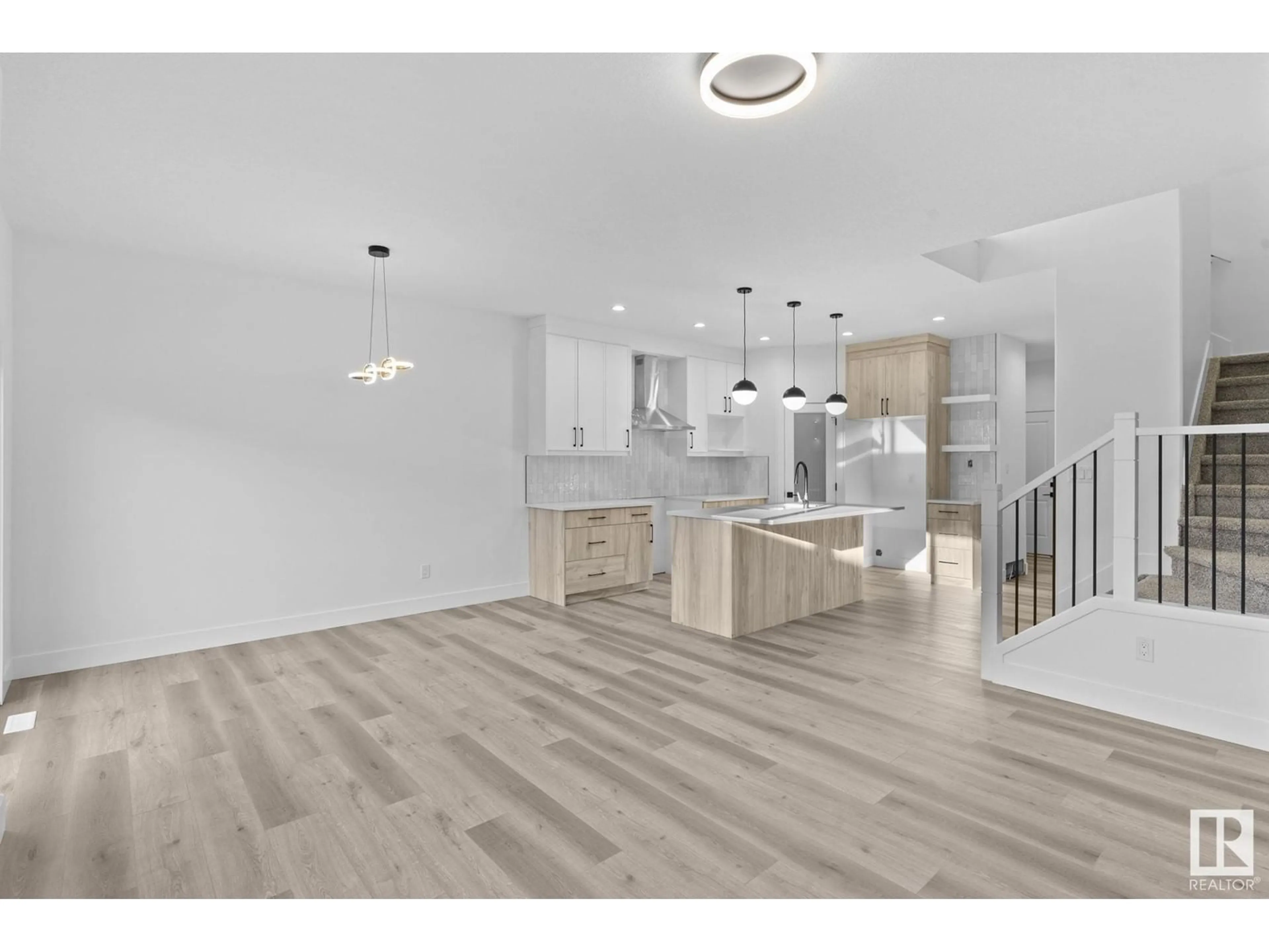 Open concept kitchen, wood/laminate floor for NW - 8823 181 AV, Edmonton Alberta T5Z0X4