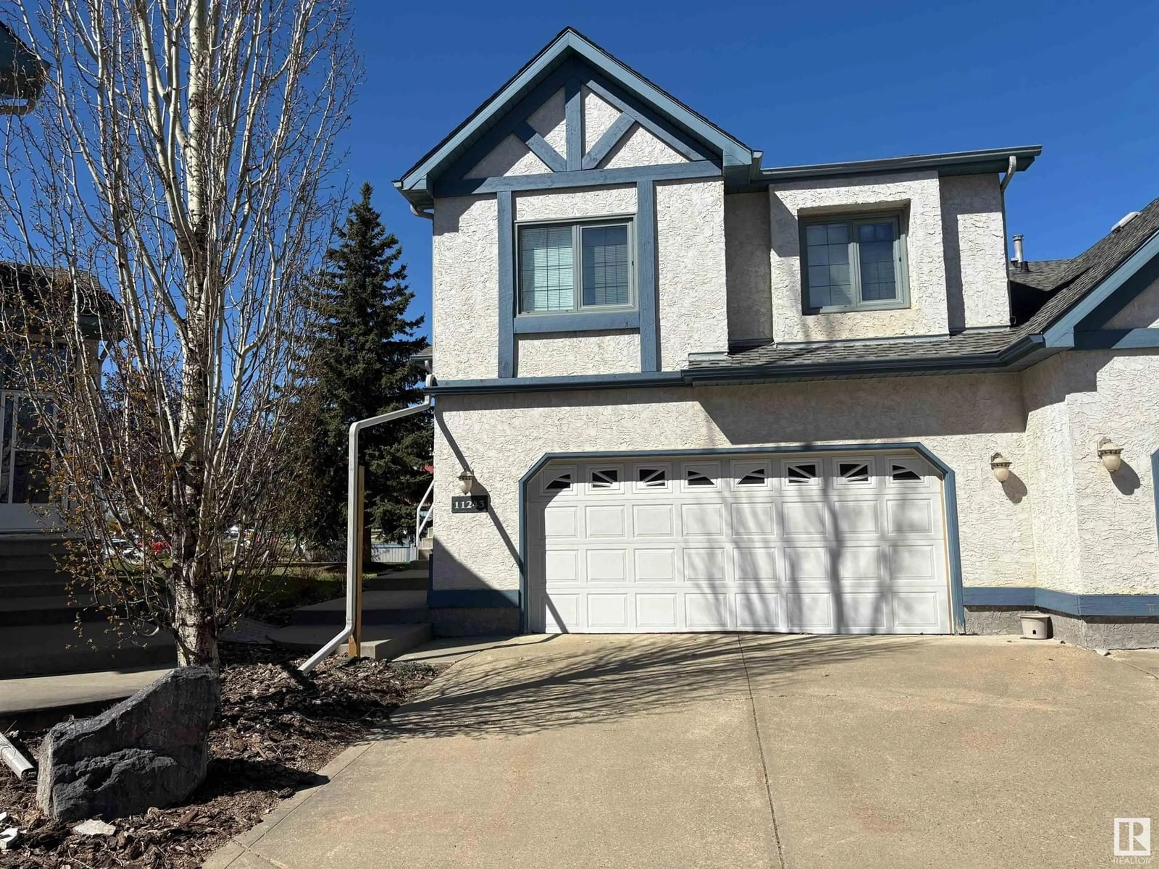 Home with vinyl exterior material, street for 11243 12 AV, Edmonton Alberta T6J6V6