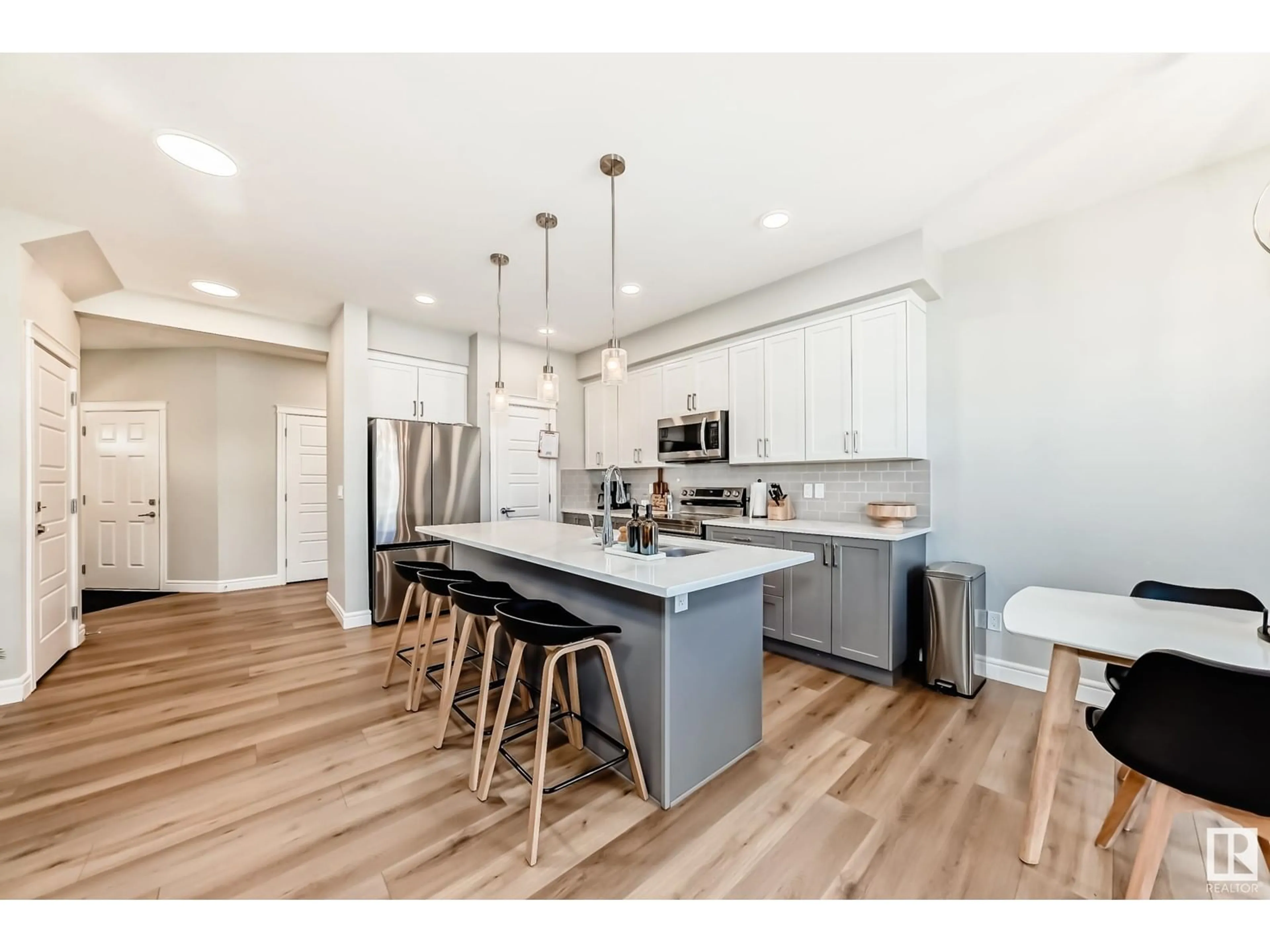 Open concept kitchen, wood/laminate floor for SW - 16216 19 AV, Edmonton Alberta T6W5C6