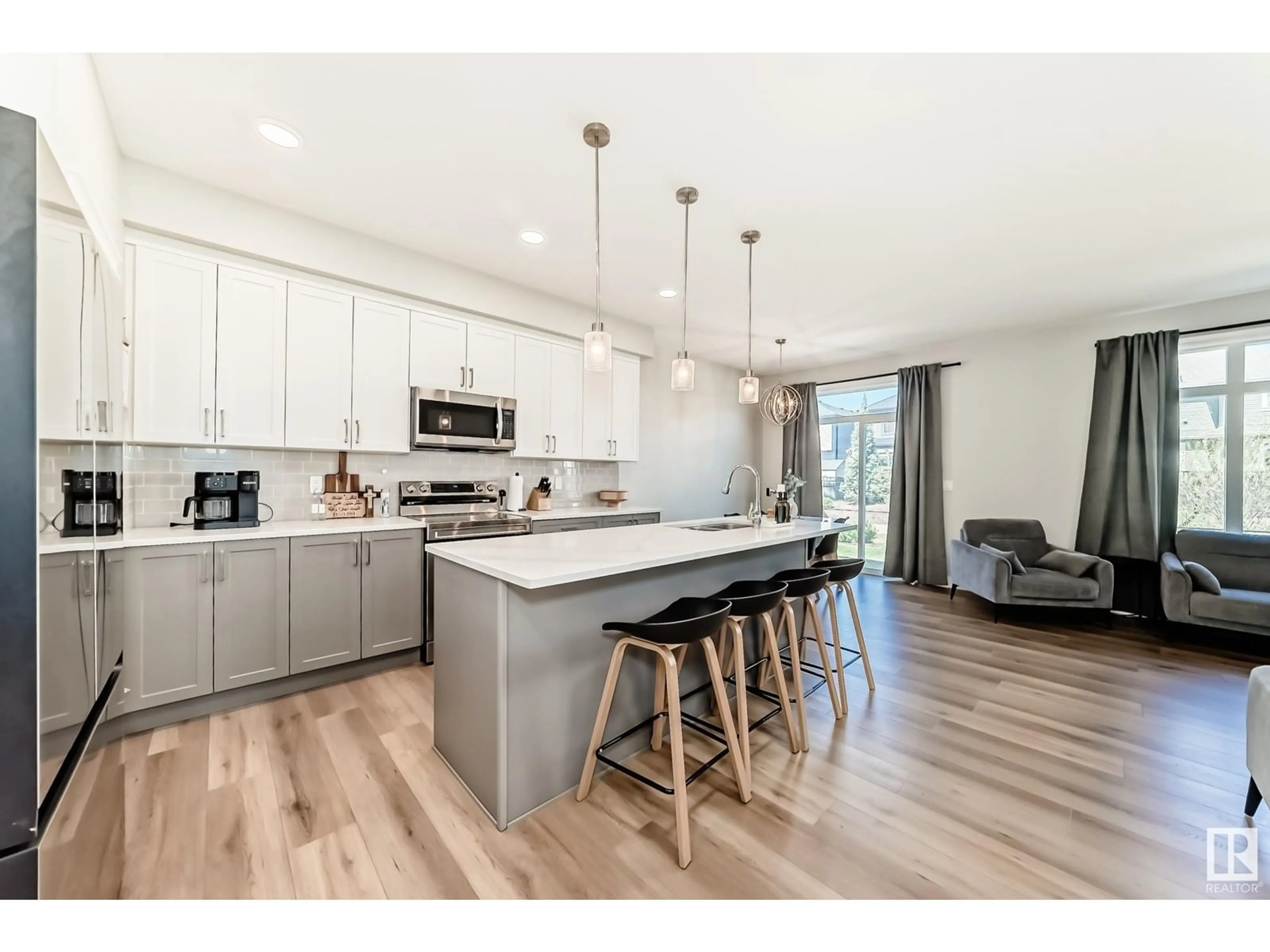 Open concept kitchen, wood/laminate floor for SW - 16216 19 AV, Edmonton Alberta T6W5C6