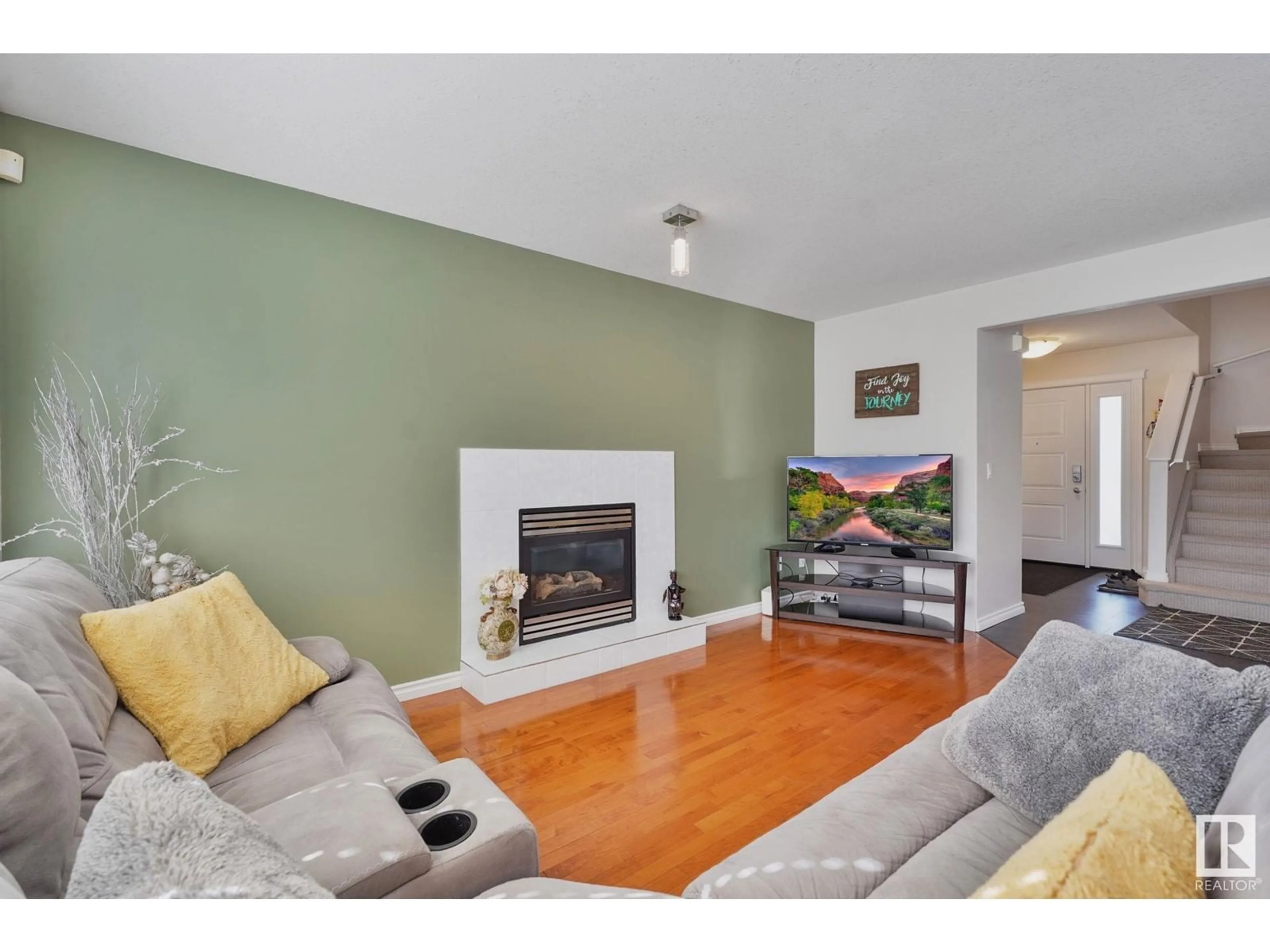 Living room with furniture, wood/laminate floor for NW - 16207 54B ST, Edmonton Alberta T5Y0E8