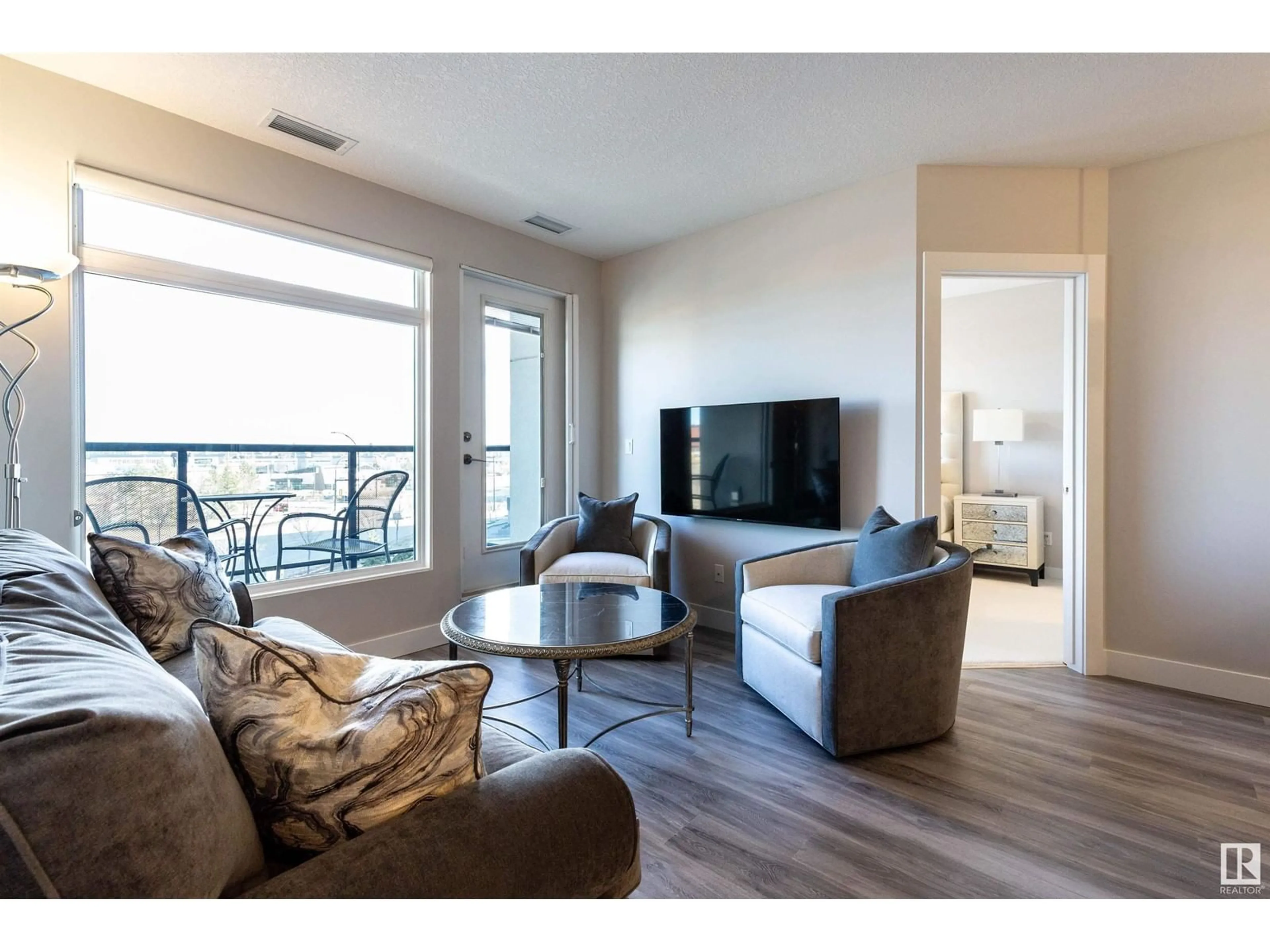 Living room with furniture, wood/laminate floor for 5151 - 430 WINDERMERE BV, Edmonton Alberta T6W2K4