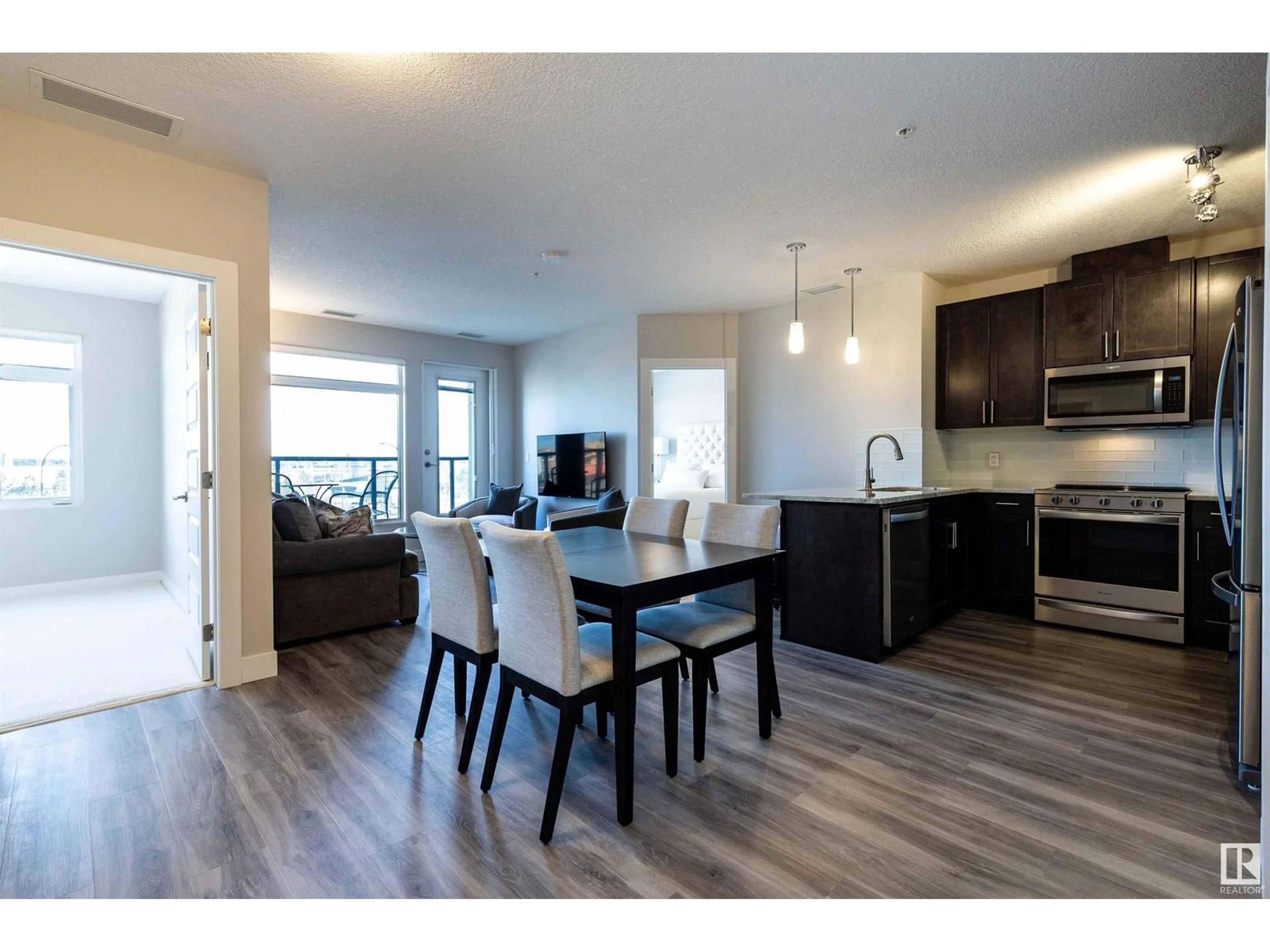 Open concept kitchen, wood/laminate floor for 5151 - 430 WINDERMERE BV, Edmonton Alberta T6W2K4