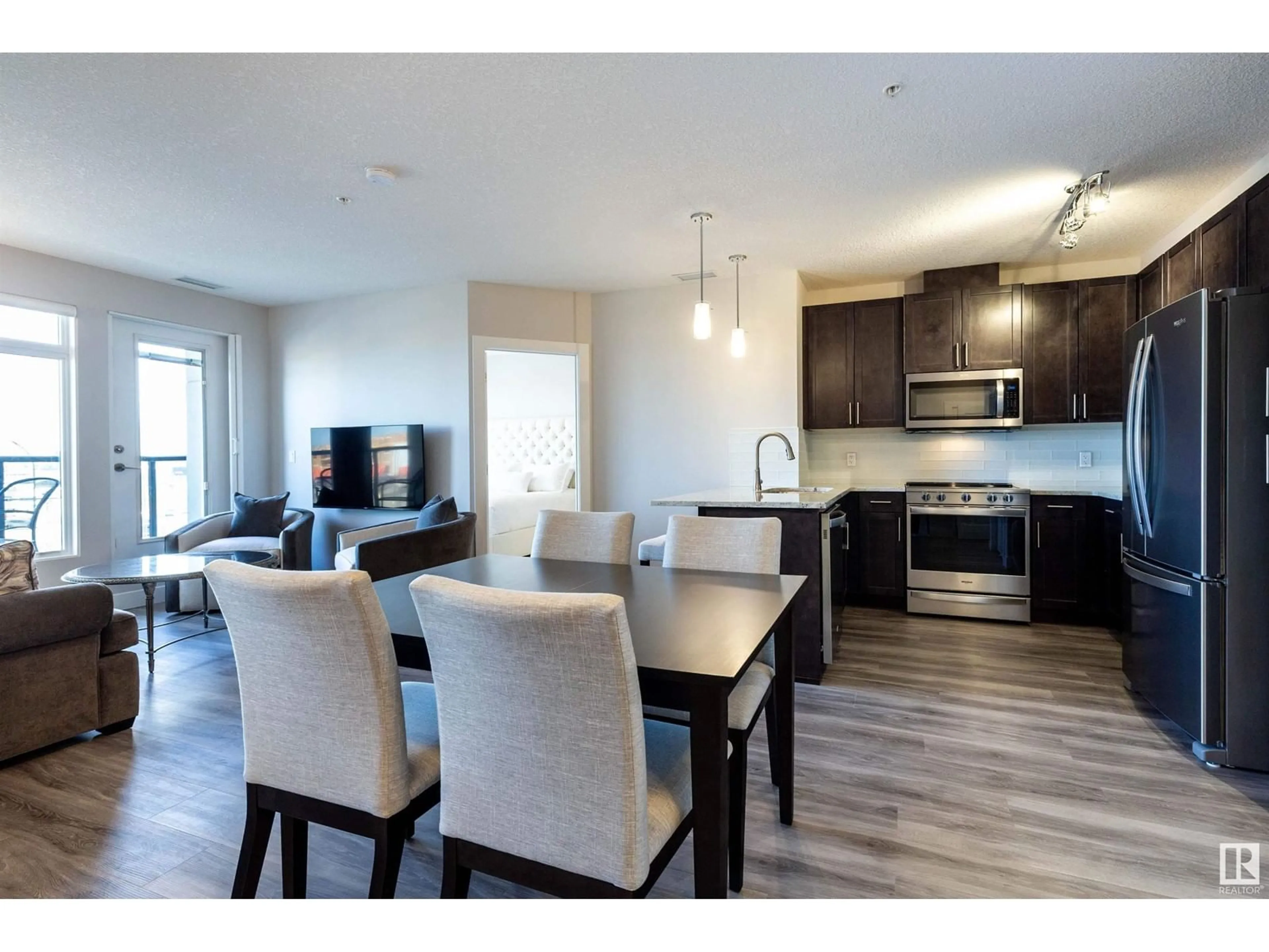 Open concept kitchen, wood/laminate floor for 5151 - 430 WINDERMERE BV, Edmonton Alberta T6W2K4