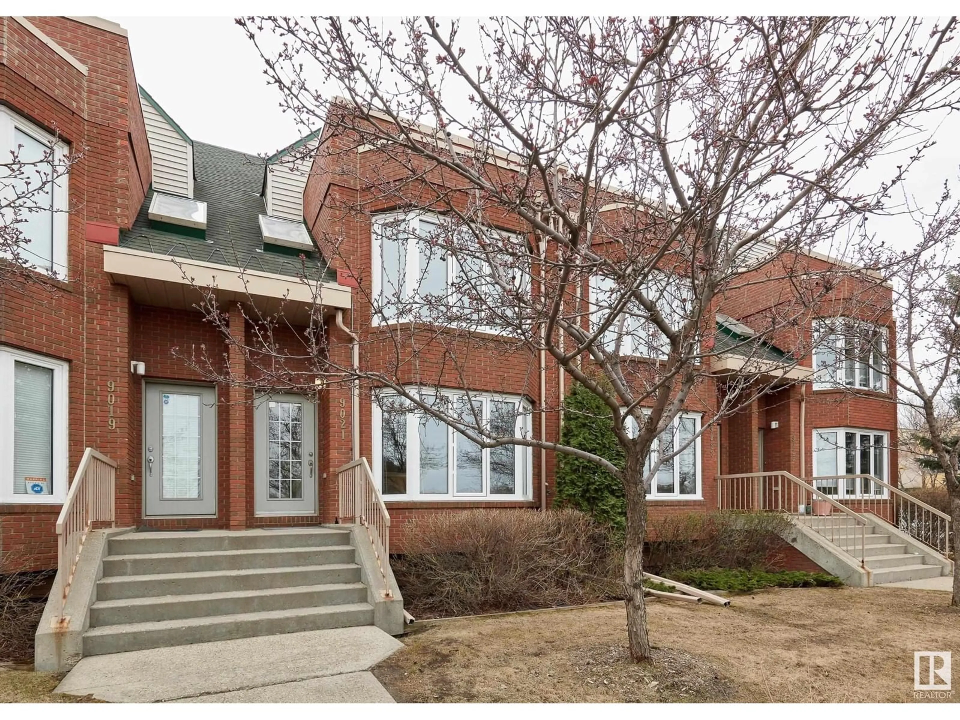 Home with brick exterior material, street for 9021 98 AV, Edmonton Alberta T6C4P2
