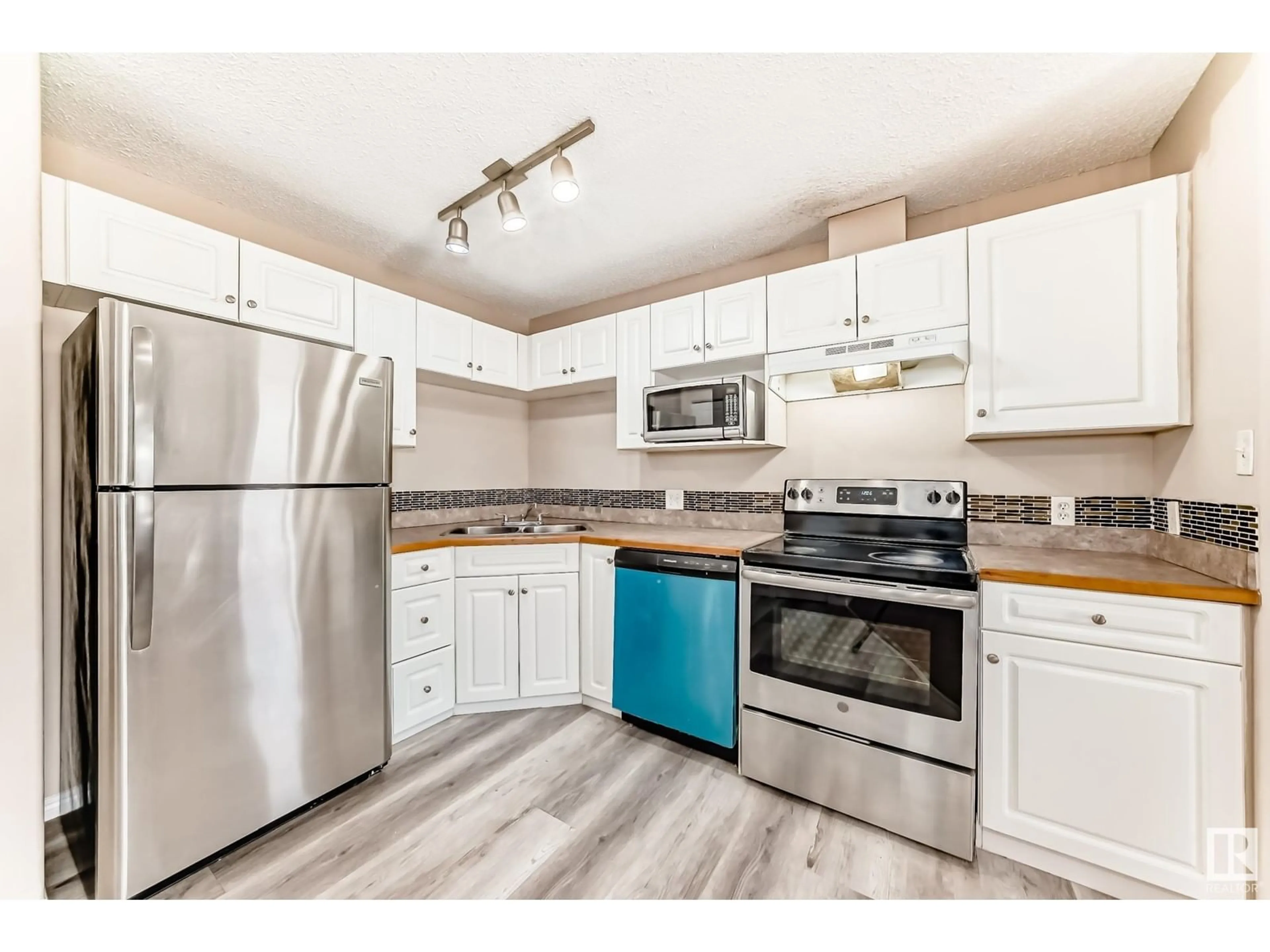 Standard kitchen, wood/laminate floor for #135 - 3425 19 ST, Edmonton Alberta T6T2B5
