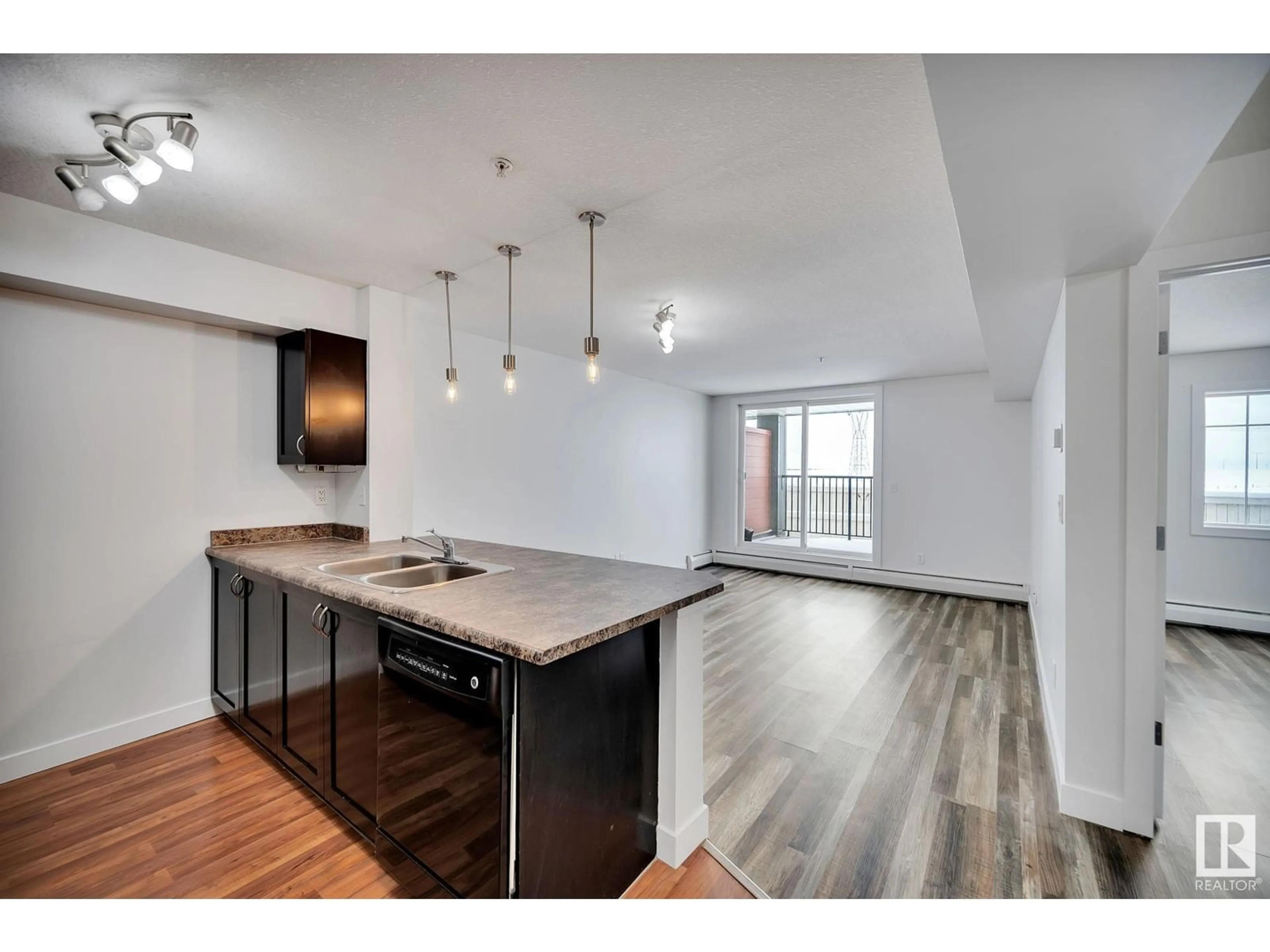 Open concept kitchen, wood/laminate floor for #112 - 920 156 ST, Edmonton Alberta T6R0N6