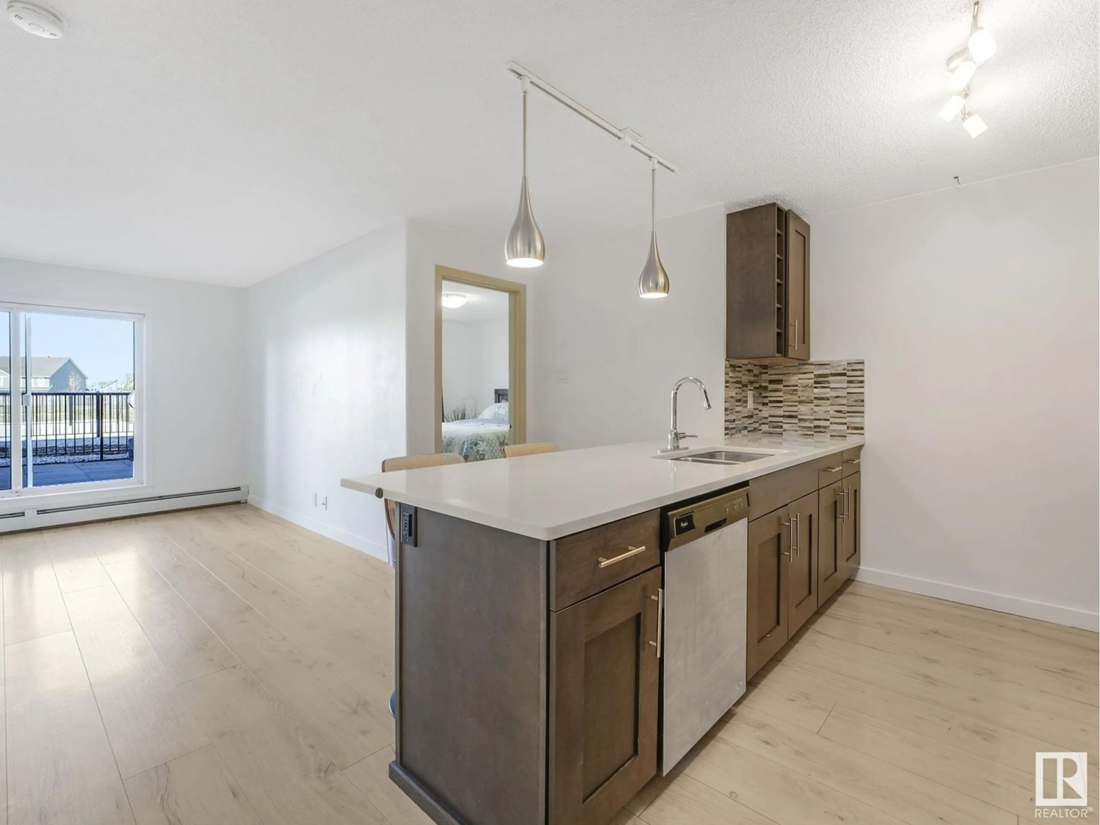 Open concept kitchen, wood/laminate floor for 4008 - 120 SAVARYN DR, Edmonton Alberta T6X2E5