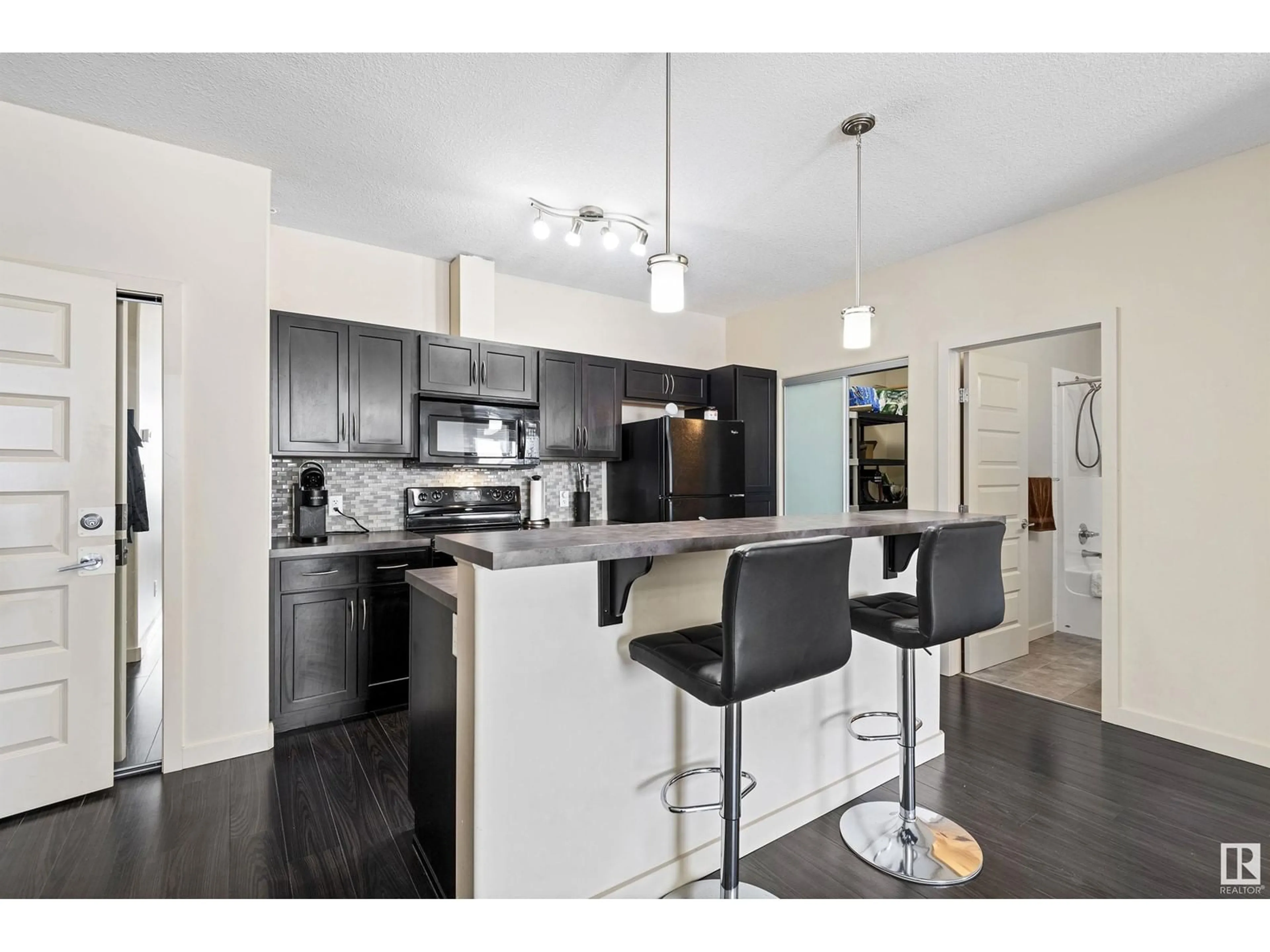 Open concept kitchen, wood/laminate floor for 304 - 418 AMBLESIDE LINK LI, Edmonton Alberta T6W0V2
