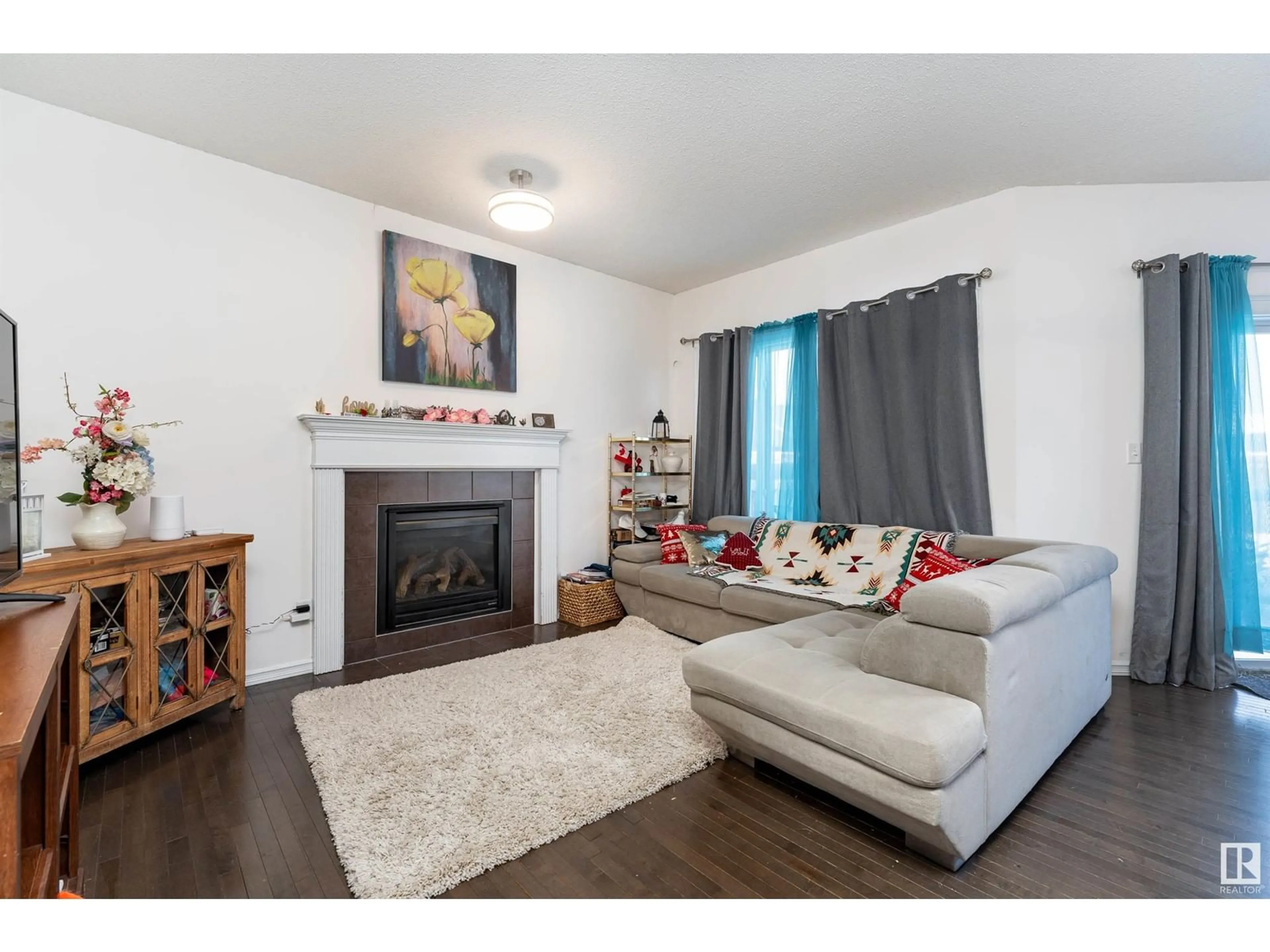 Living room with furniture, wood/laminate floor for 10302 96 ST, Morinville Alberta T8R0B4