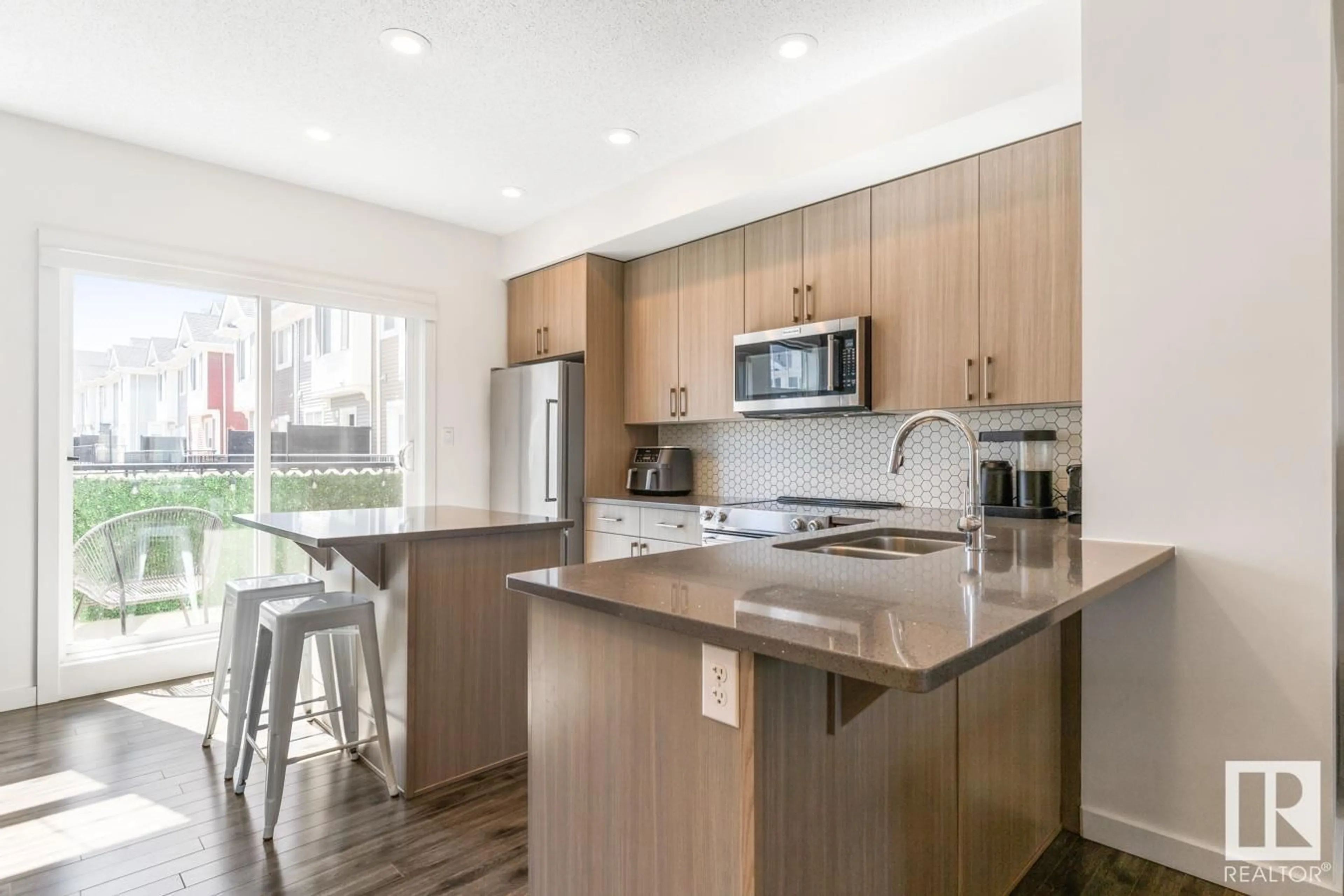 Open concept kitchen, wood/laminate floor for #4 - 2803 JAMES MOWATT TR, Edmonton Alberta T6W2P5