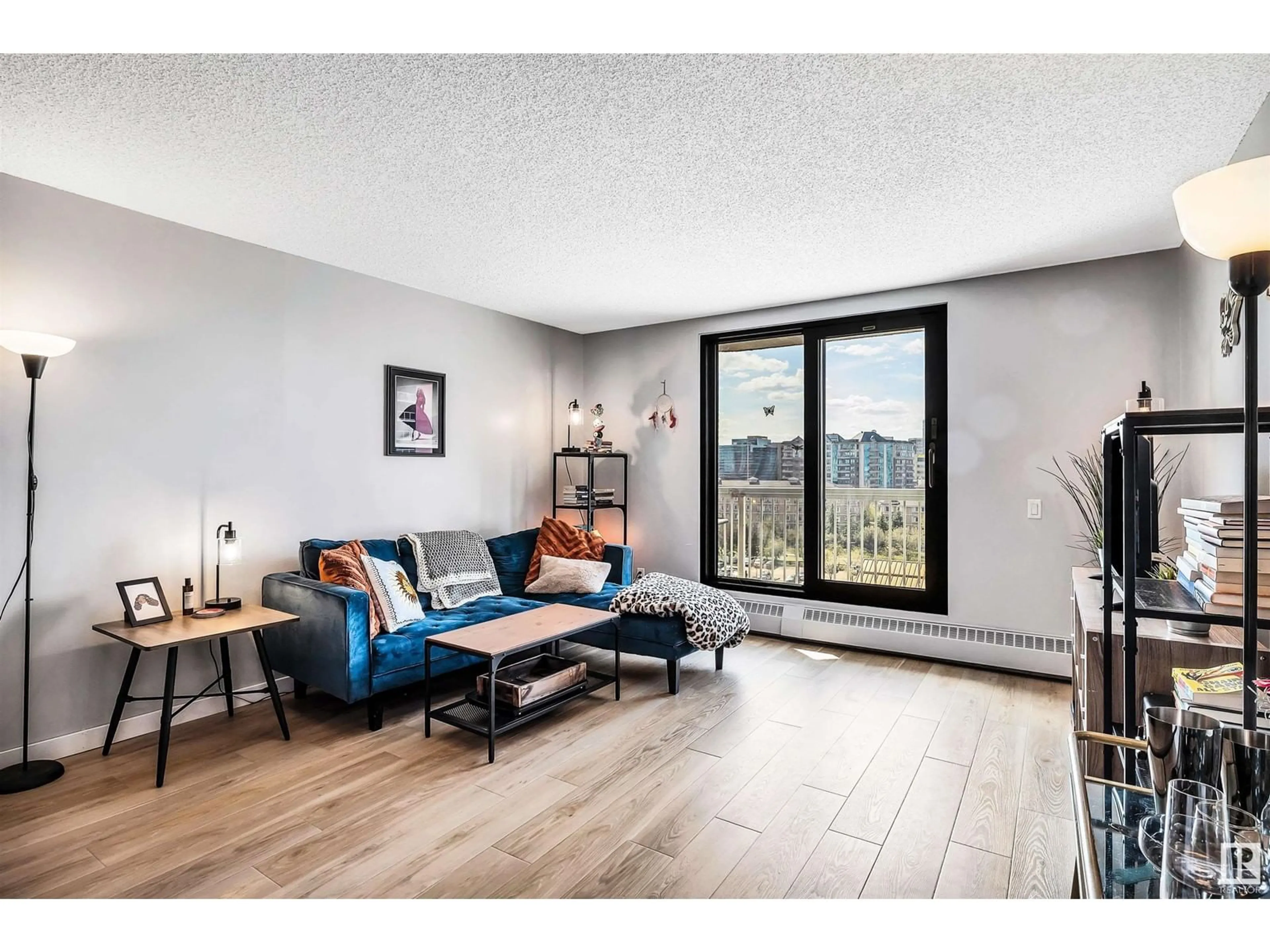 Living room with furniture, wood/laminate floor for 705 - 10175 109 ST, Edmonton Alberta T5J3P2